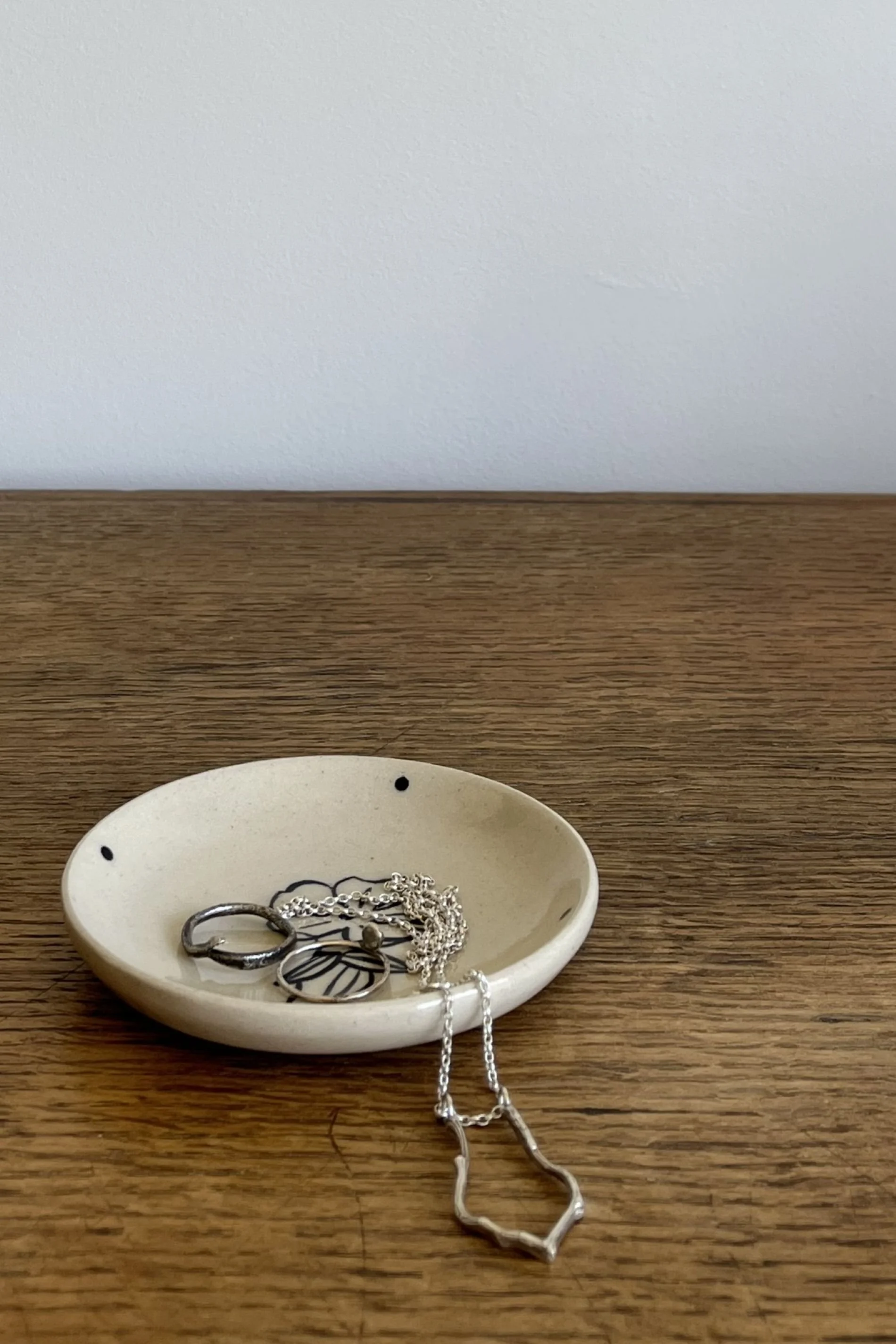 Handmade stoneware Trinket Dish with flower design with jewellery.