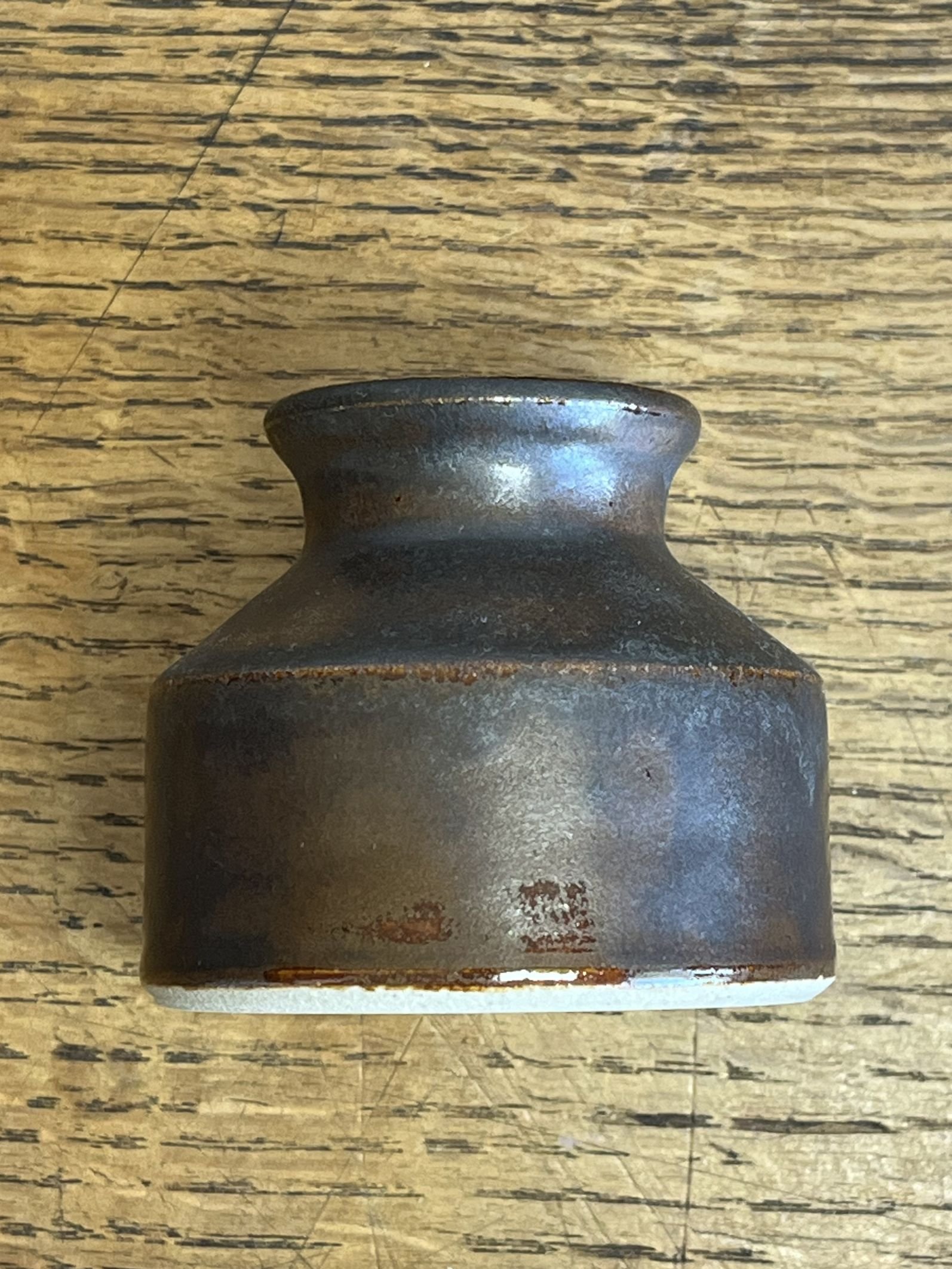 hand made stoneware bud vase in a deep brown glaze