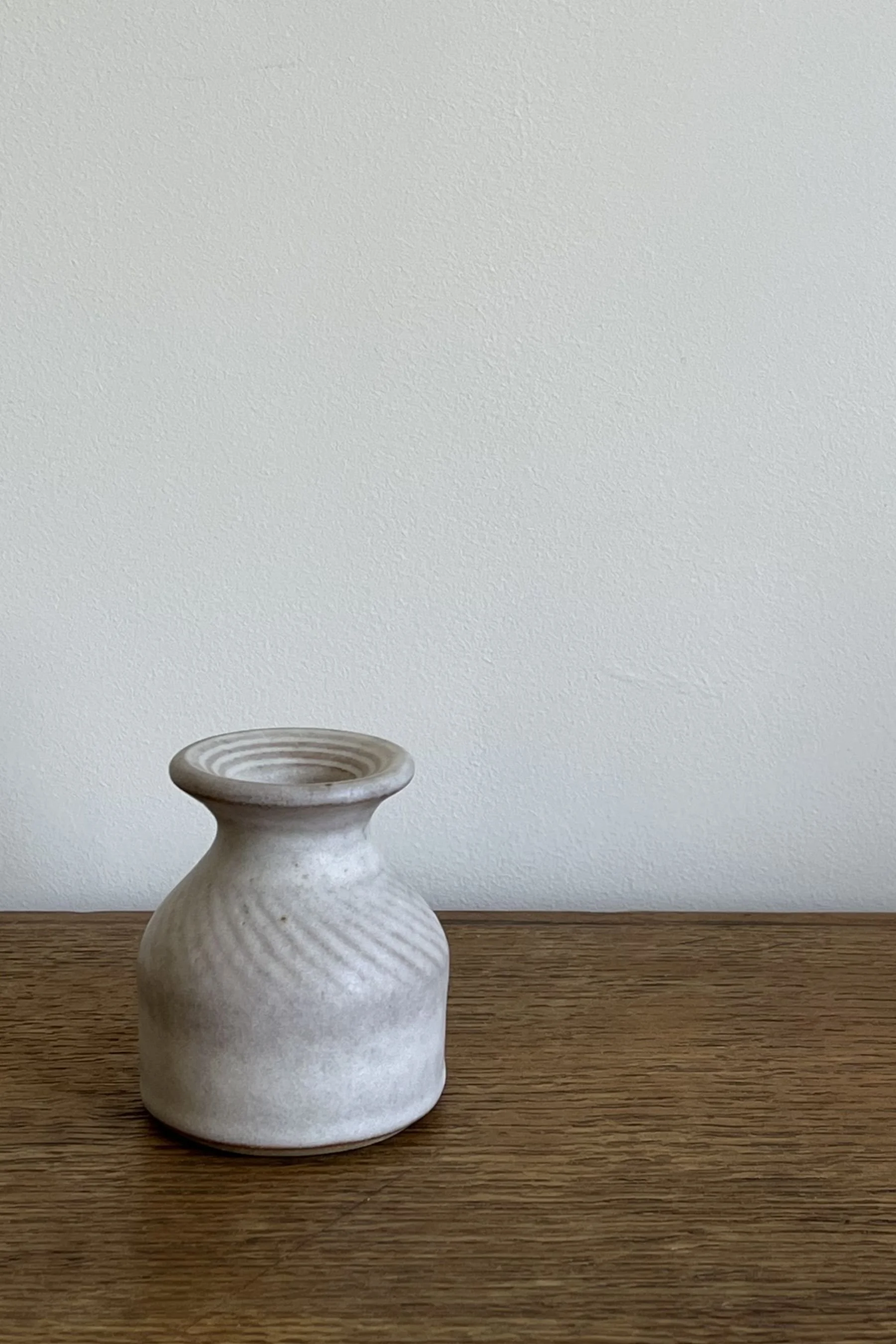 Handmade Stoneware Bud Vase with Carving Detail in an off-white satin glaze.