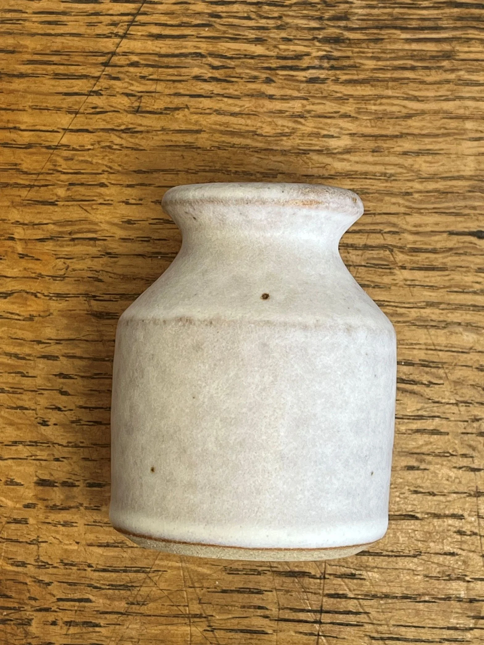 hand made stoneware bud vase in an off-white glaze