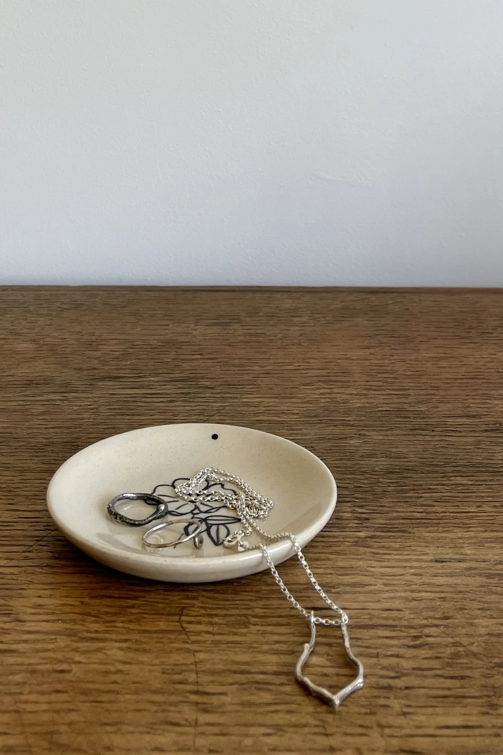Handmade Stoneware Trinket Dish with flower design and jewellery.
