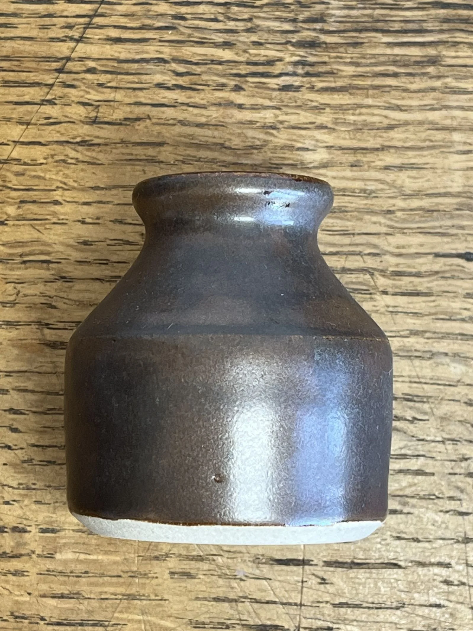 hand made stoneware bud vase in a deep brown glaze