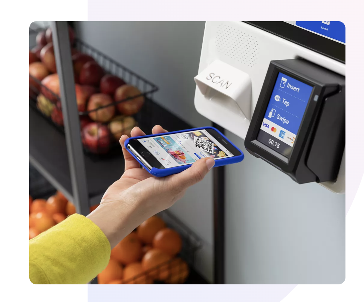 Person using a smartphone to scan a QR code at a contactless checkout terminal in a grocery store, with apples and oranges in the background.Smart Cooler, Smart Market, Smart Store