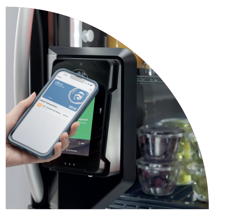 Person using a smartphone to make a contactless payment at a vending machine or kiosk in a grocery store.Sart Cooler, Smart Market, Smart Store