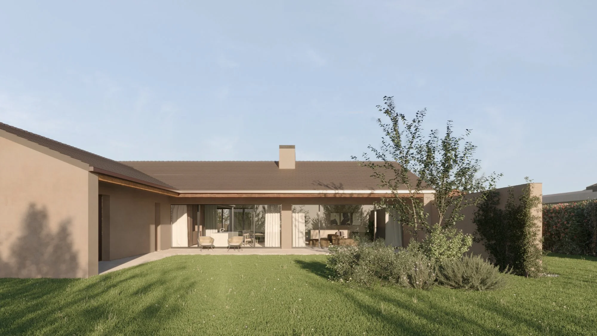 Casa moderna con giardino verde e alberi, pareti di colore beige e tetto a falda.