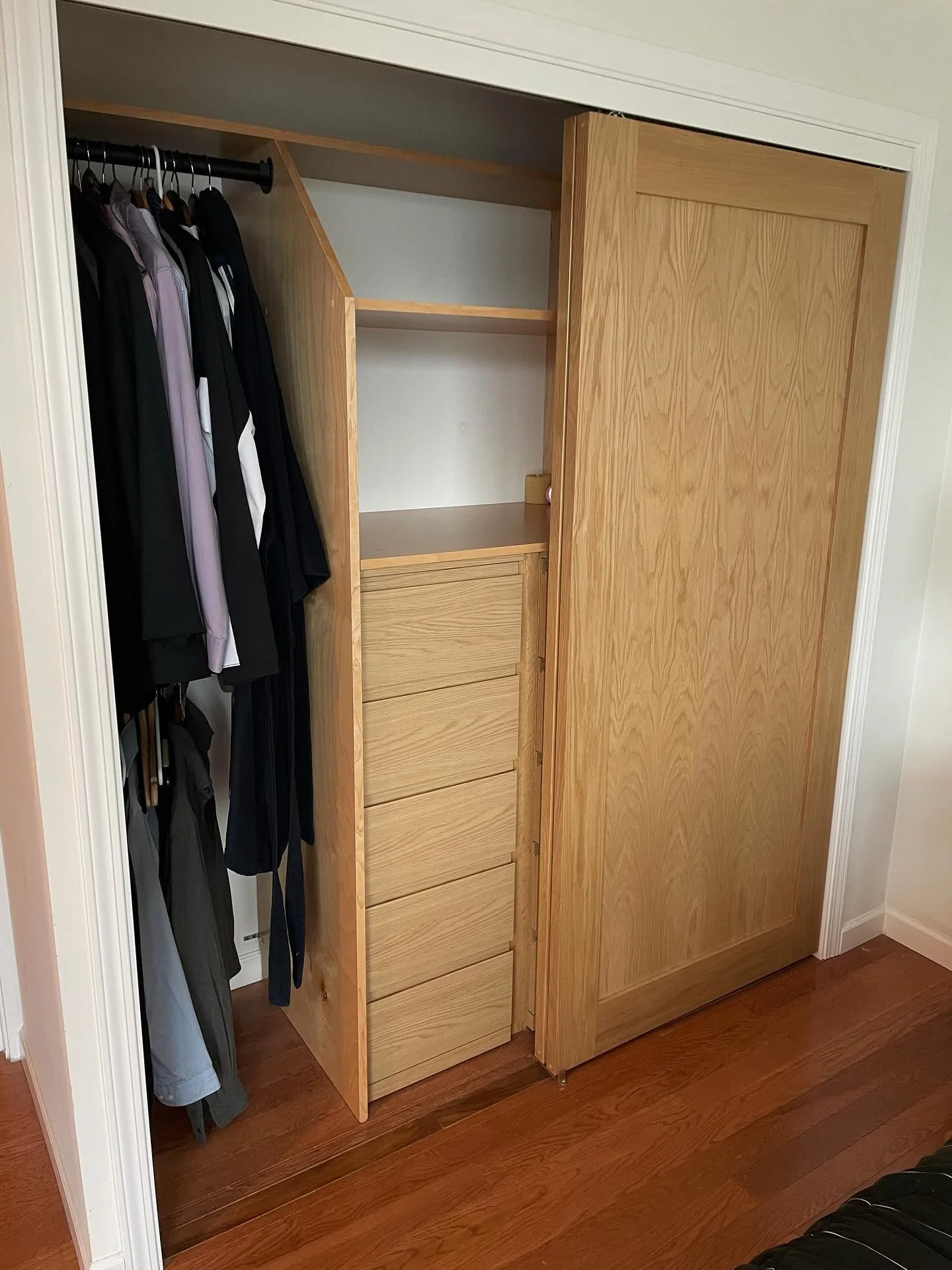 His and hers split master bedroom closet. Bifold&rsquo;s out, solid white oak bypass doors in! Built in drawers, shelves, and hanging space provide ample storage.