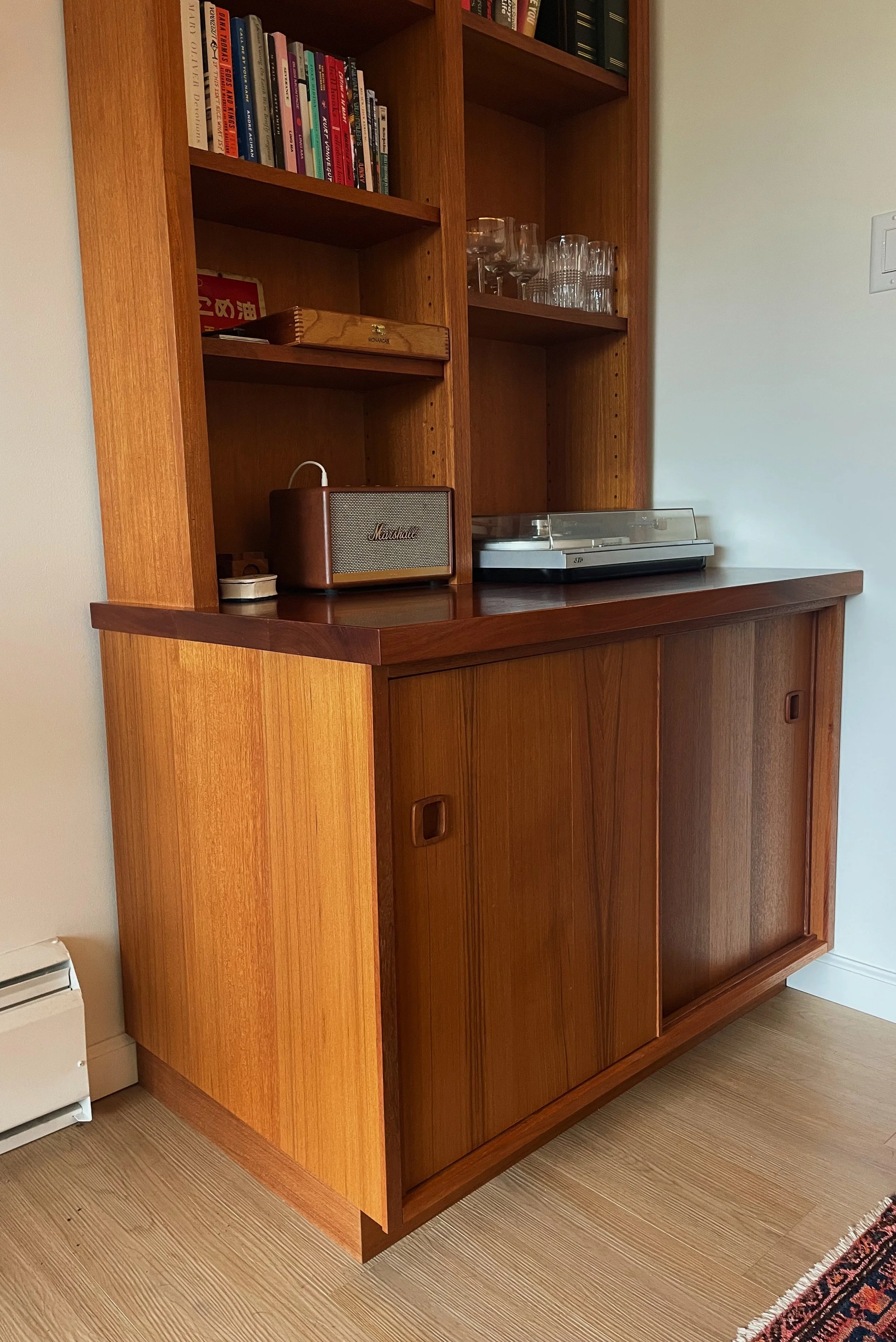 Custom wood record player bookshelf with built-in shelving by Herringbone Contracting, Vancouver