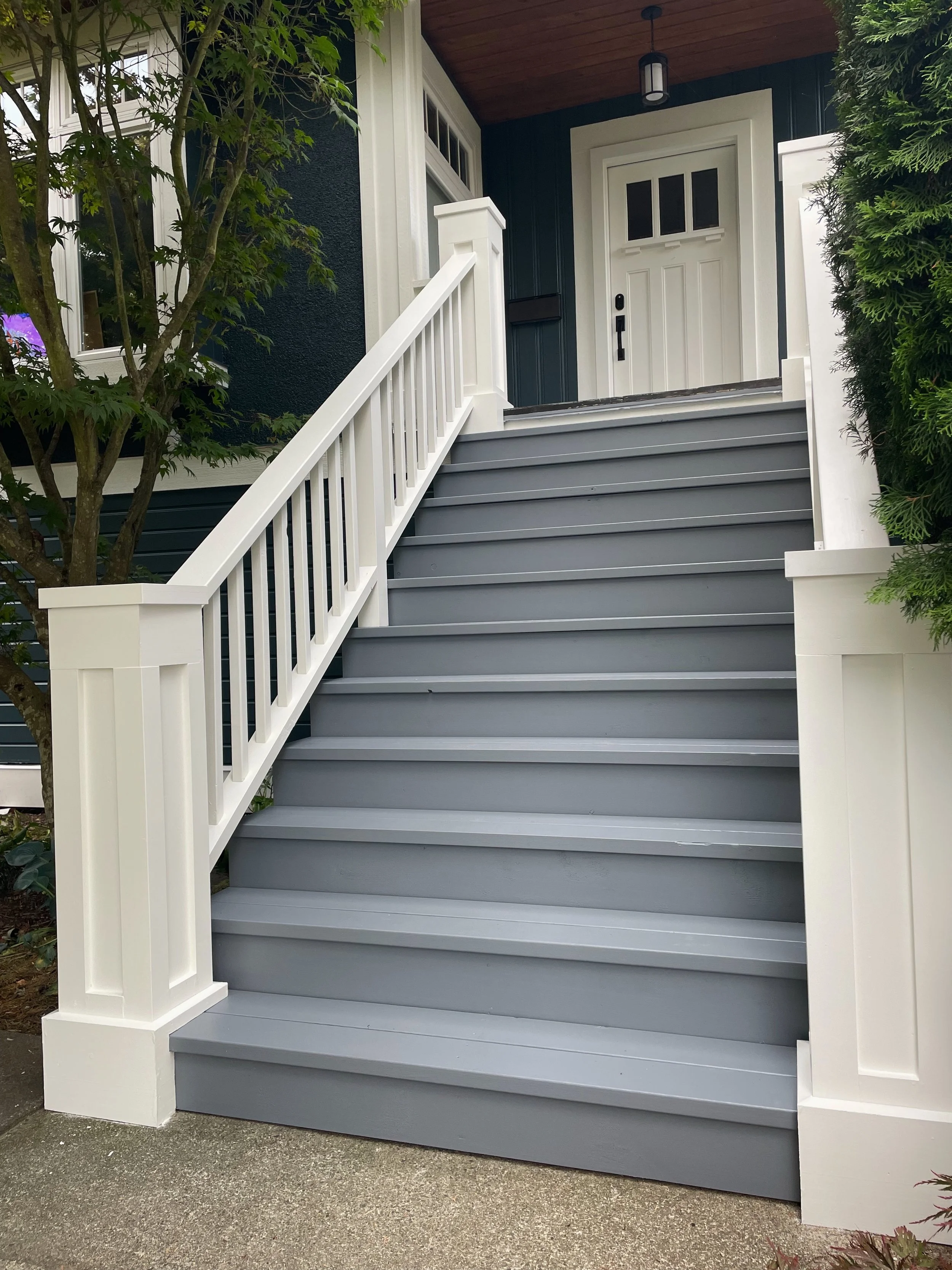 Heritage-inspired wood exterior staircase designed and built by Herringbone Contracting, Vancouver