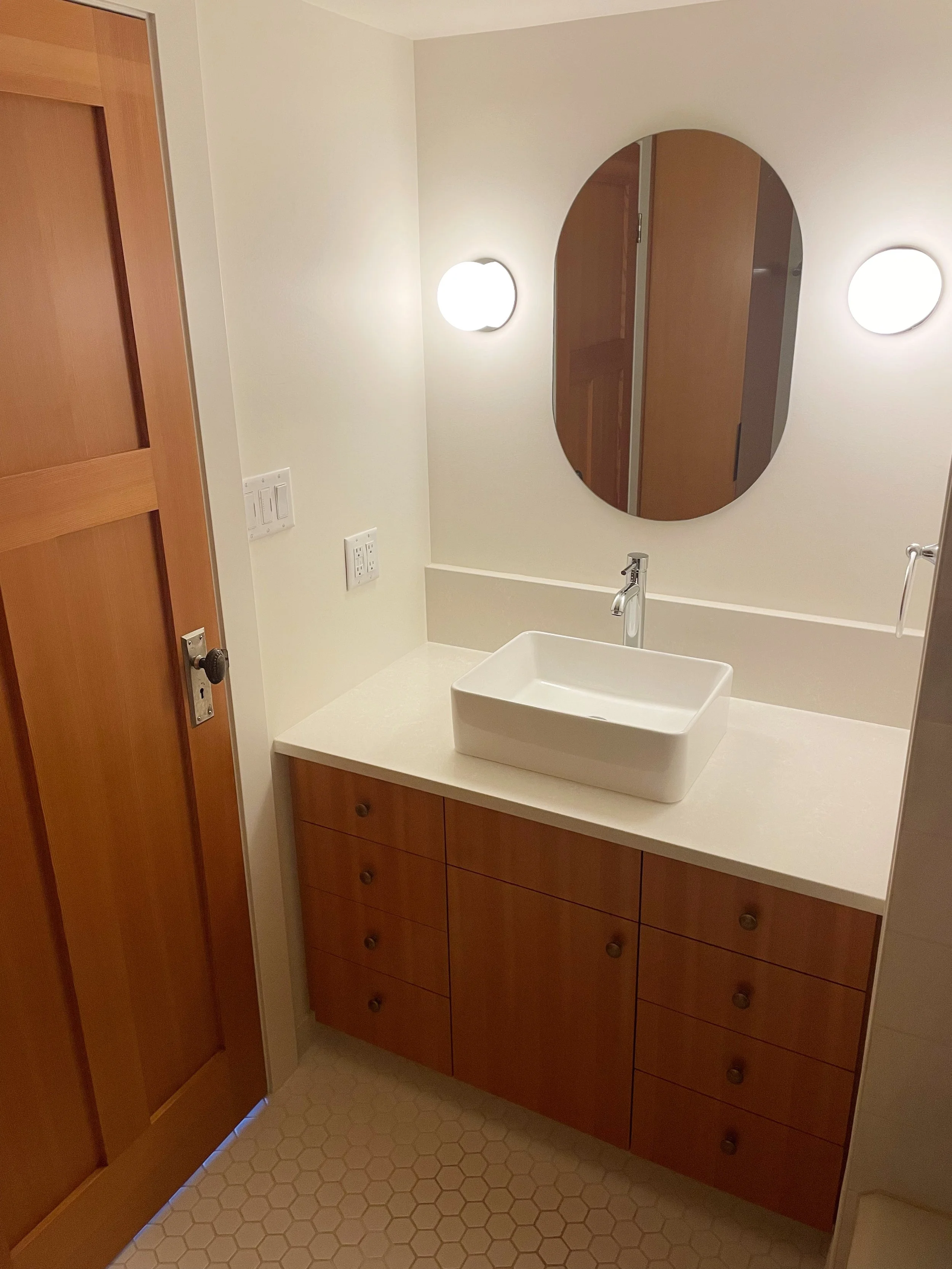 Custom bathroom renovation with quartz countertop and fir wood vanity by Herringbone Contracting, Vancouver