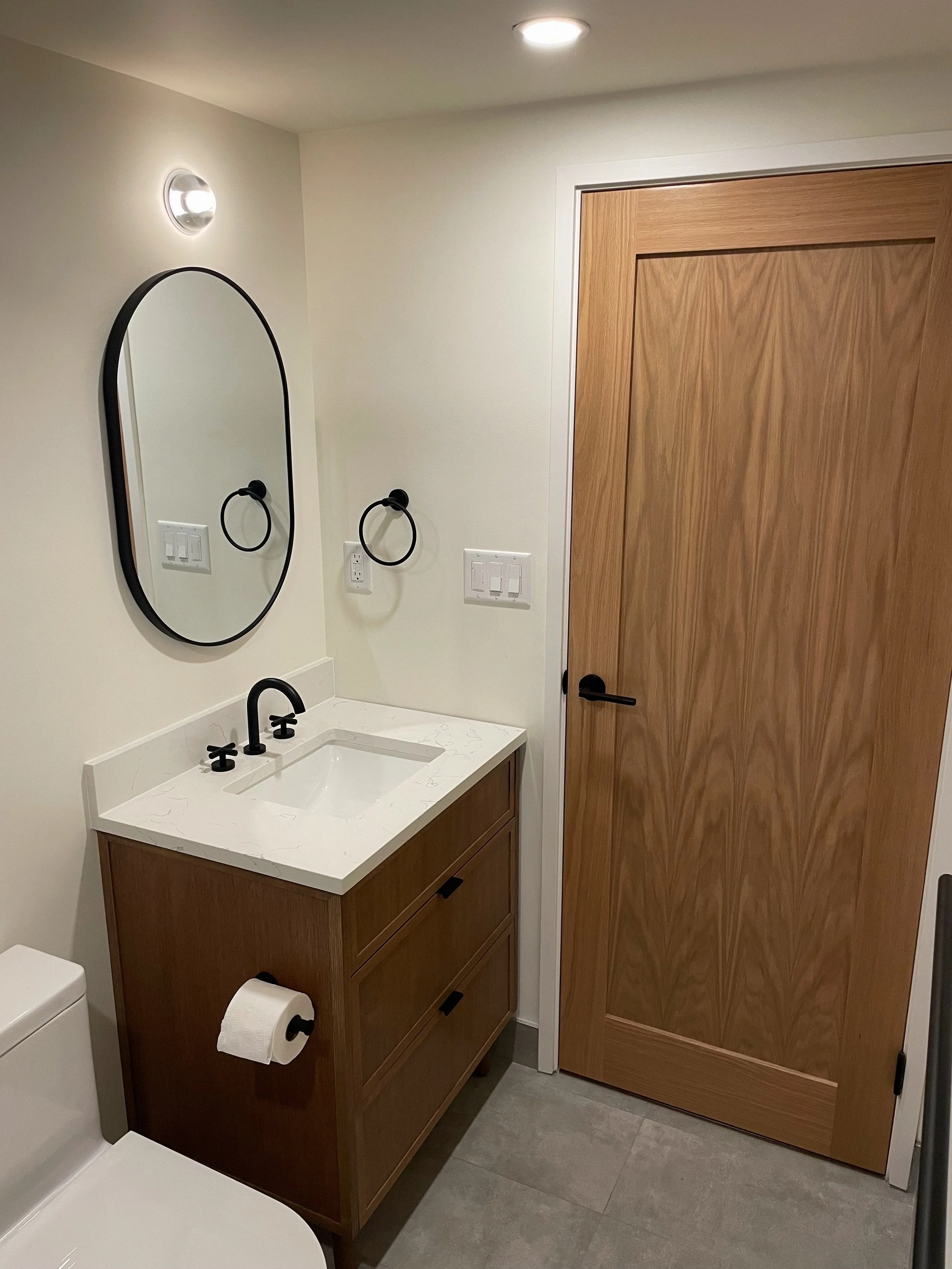Vancouver washroom renovation by Herringbone Contracting, featuring custom wood accents and timeless craftsmanship.