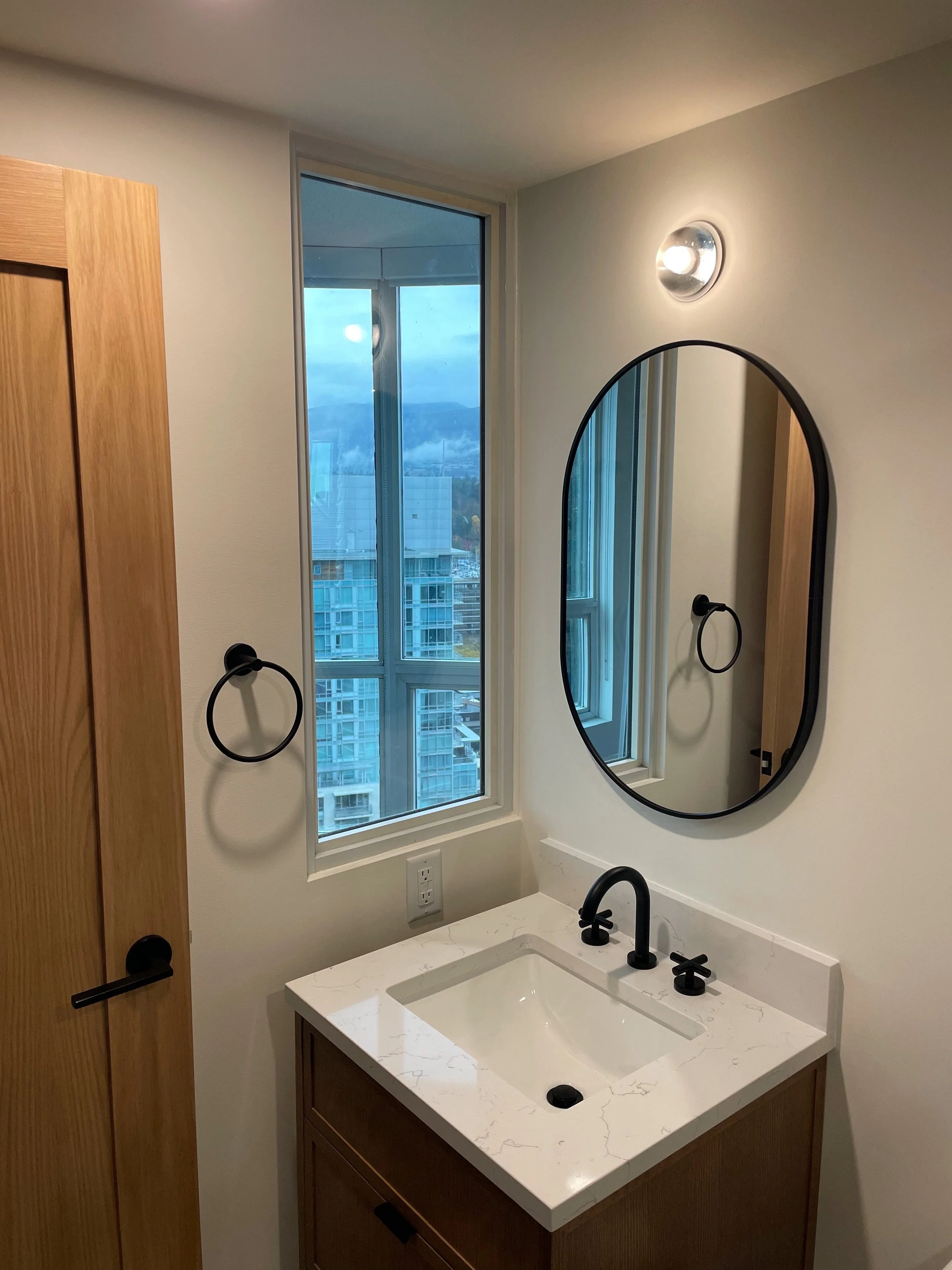 Custom millwork vanity in a luxury bathroom by Herringbone Contracting, featuring timeless craftsmanship and natural materials.