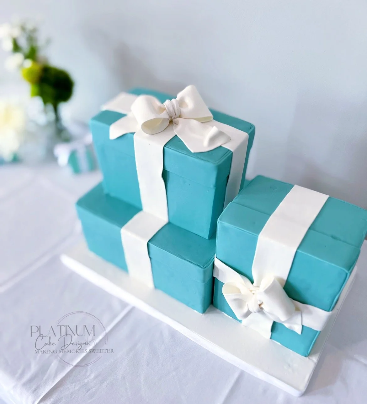 We made this Tiffany-themed wedding cake for an unconventional couple.  Part of their love story intersected with Breakfast at Tiffany's and Tiffany & Co, so we incorporated these Tiffany-like gift boxes in their wedding design, bows and all.