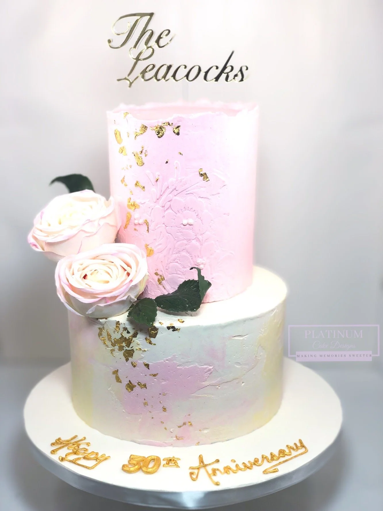 2-tiered pink and yellow stenciled anniversary cake.JPG