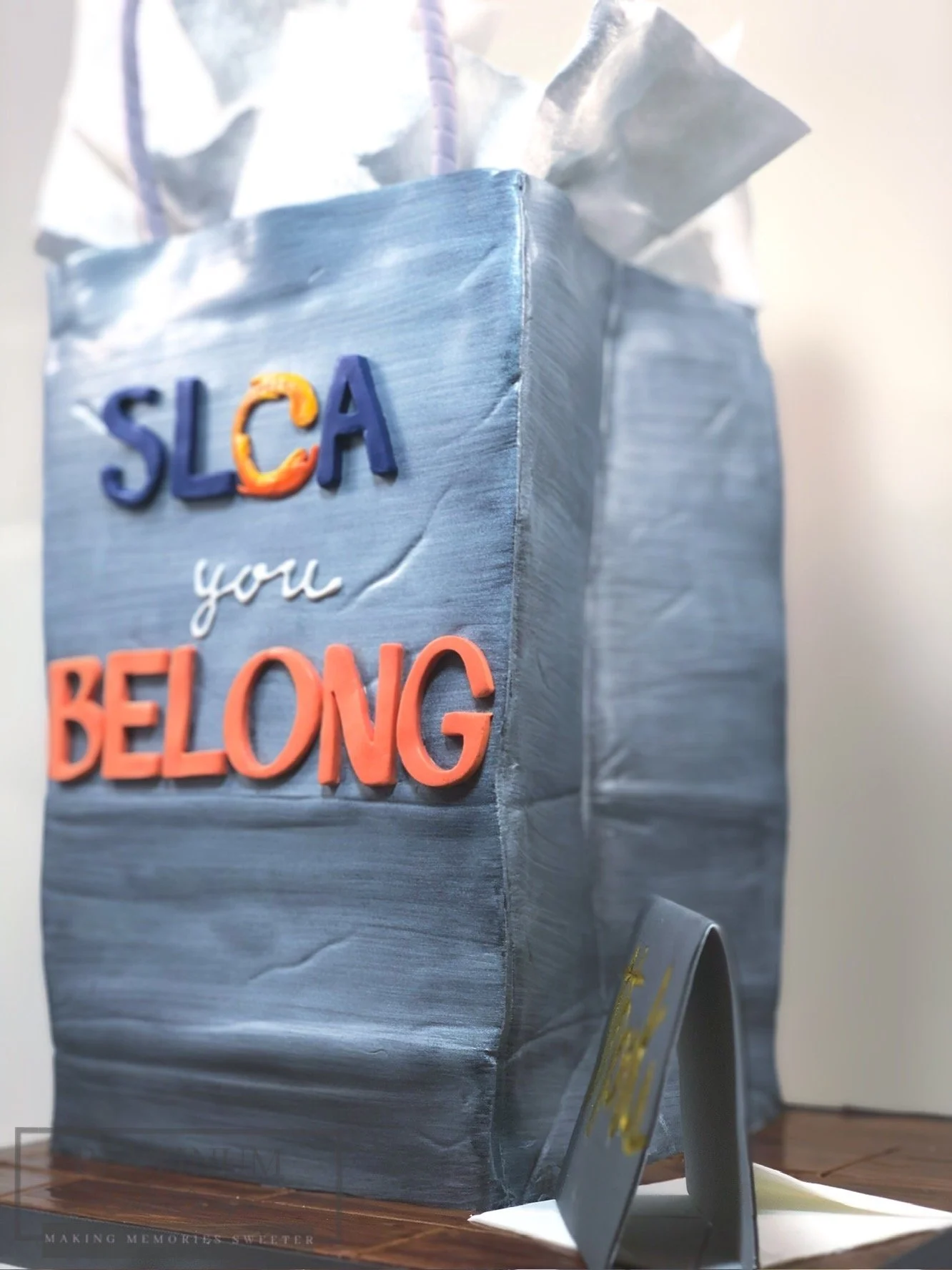 We created this sculpted cake as a gift bag with a Thank You card for an organization celebrating their volunteers.  We even topped it off with edible tissue paper and envelope.  A great way for any company to say thank you to their employees.