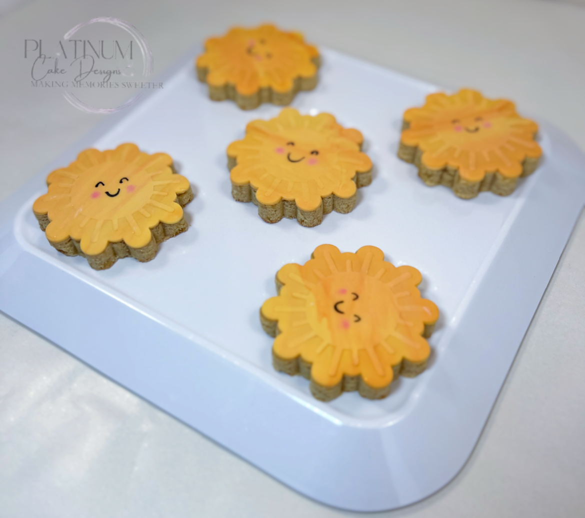Platinum Cake Designs in Decatur, GA  created these custom sugar cookies for an Assistant Principal spreading a little sunshine for parents and students.  We marbled the fondant and used an embosser to create the sunrays to add depth to the cookies.