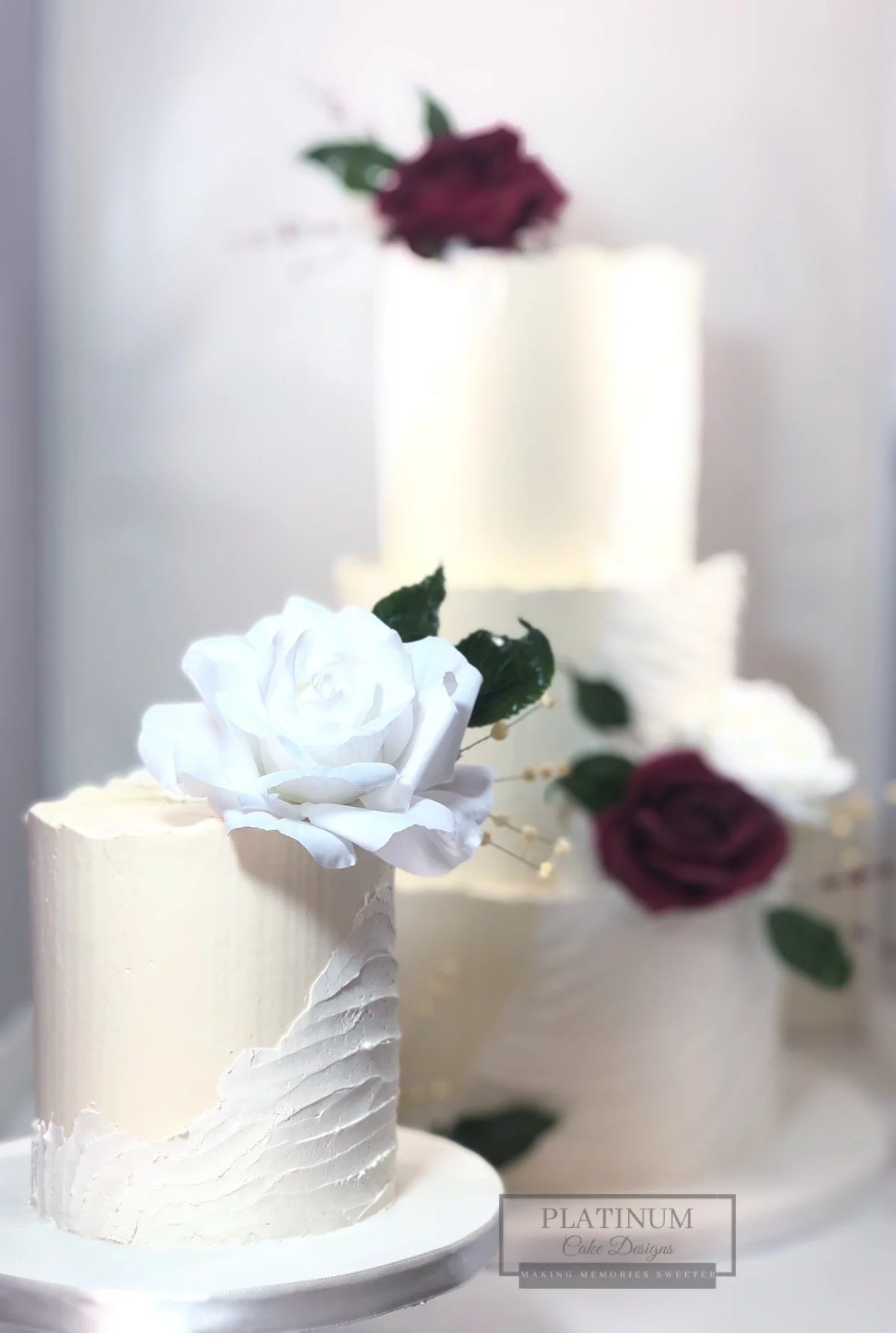 Textured rustic wedding cake with mini cake.JPG