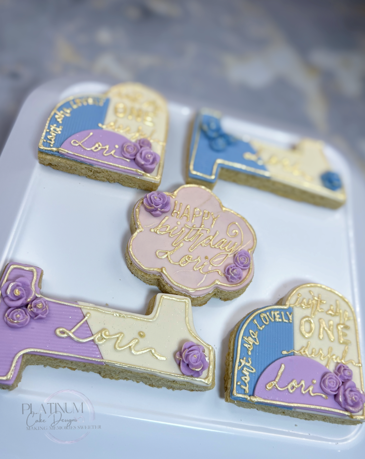 Platinum Cake Designs created this beautiful custom sugar cookie set for a Onederful little girl's birthday.  The theme for this 1 year old's birthday was based on Stevie Wonder's song, "It's She Lovely", so we customized the cookie set by piping her