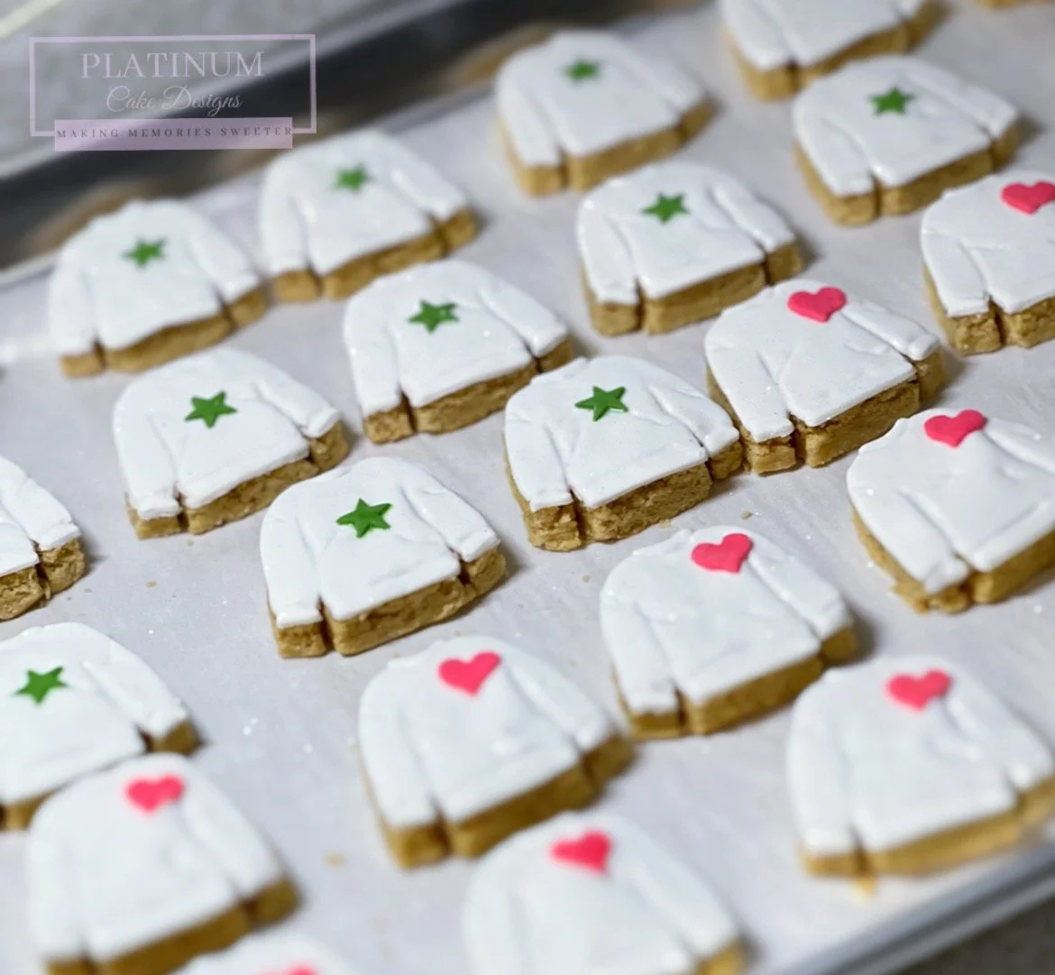 We created these mini sweater sugar cookies with a pink heart and green star for a special presentation at Mosaic Minds Art Academy for group of young artists.