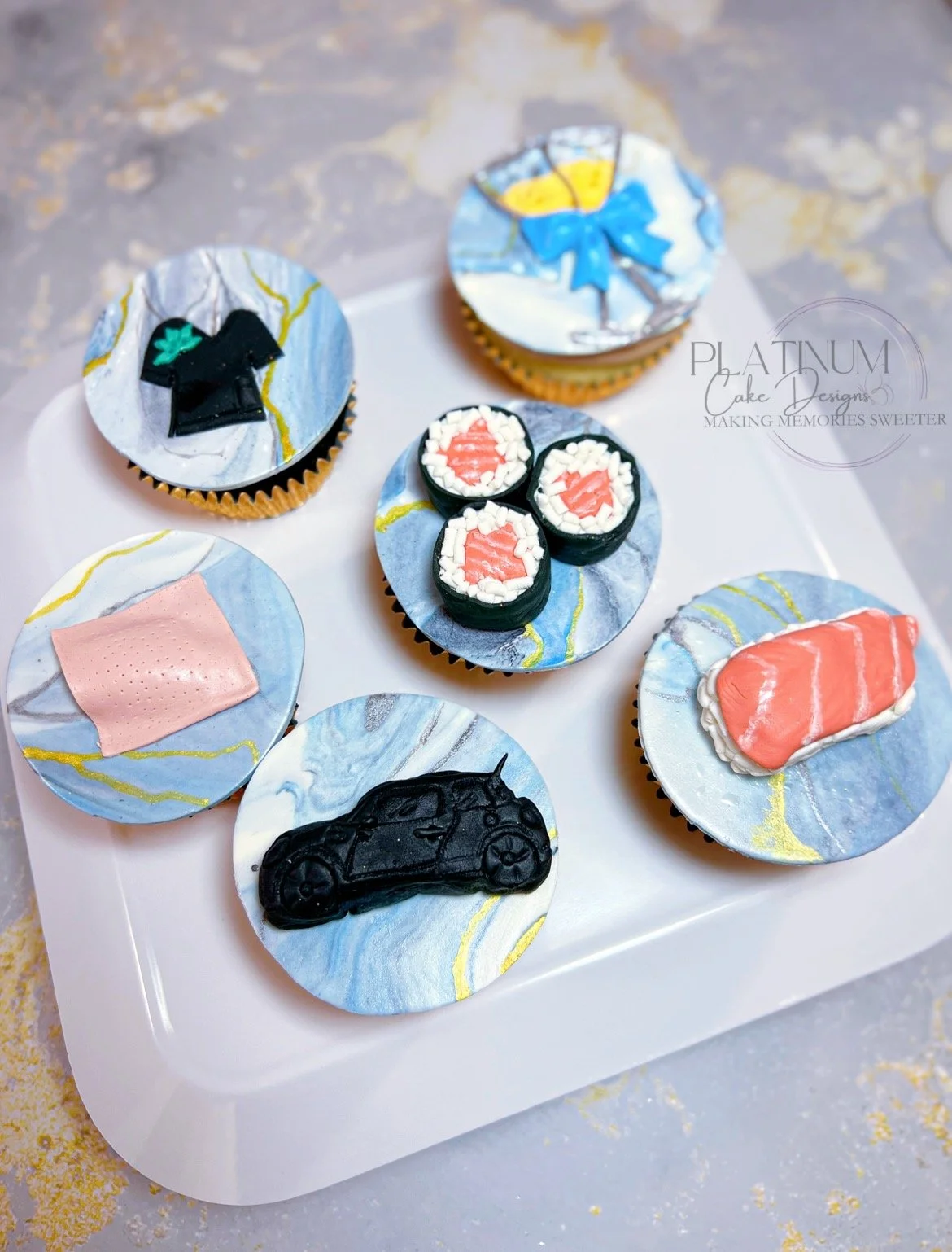 We created these delicious cupcakes for an OB / GYN's office celebrating one of their doctor's birthdays and her favorite things.  We made edible sushi toppers, a mini Cooper, the patch, a scrubs with the company logo, and some champagne flutes with 