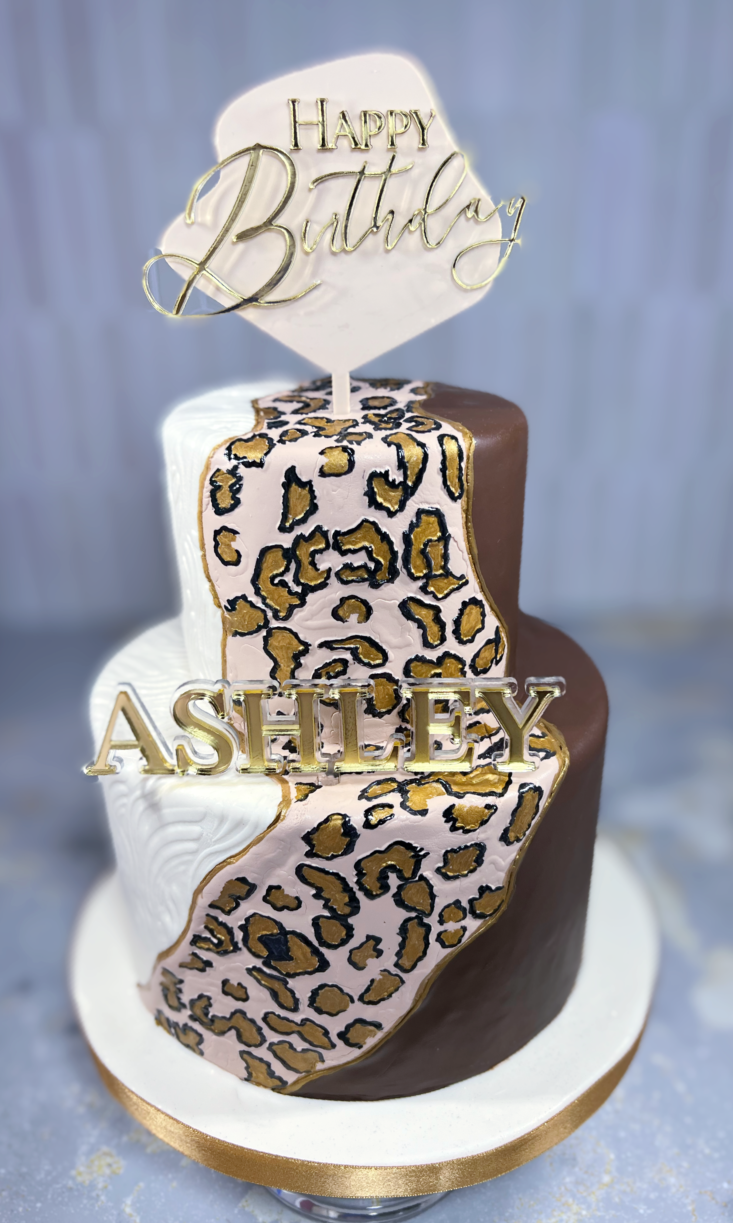 We made this custom birthday cake for a birthday celebrant who a maximalist.  We textured the cream layer, embossed and hand painted the leopard print, and a smooth brown fondant along with 2 custom acrylic cake toppers to give a maximalist feel.