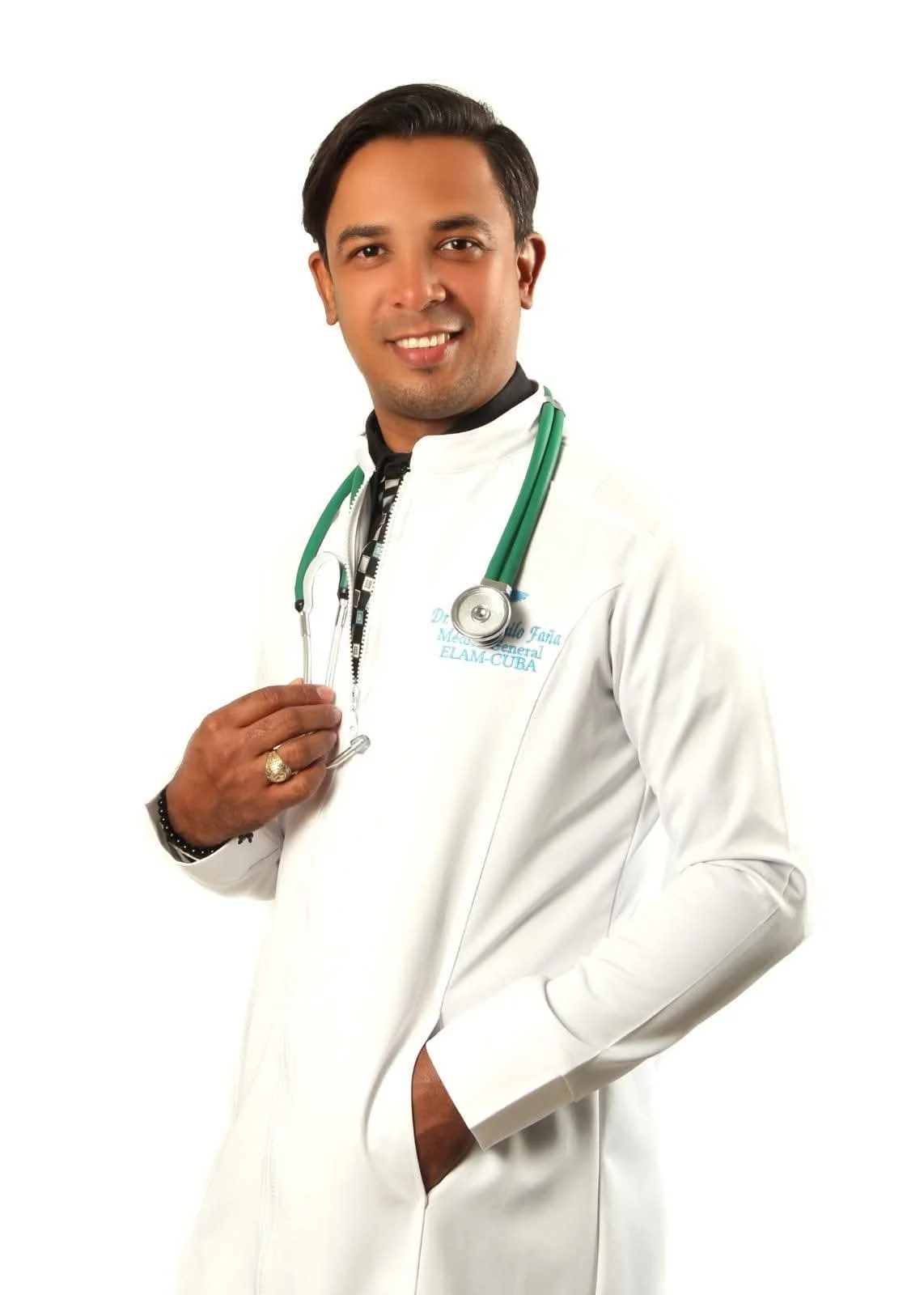 A male doctor wearing a white lab coat with a stethoscope around his neck, smiling and posing against a white background.