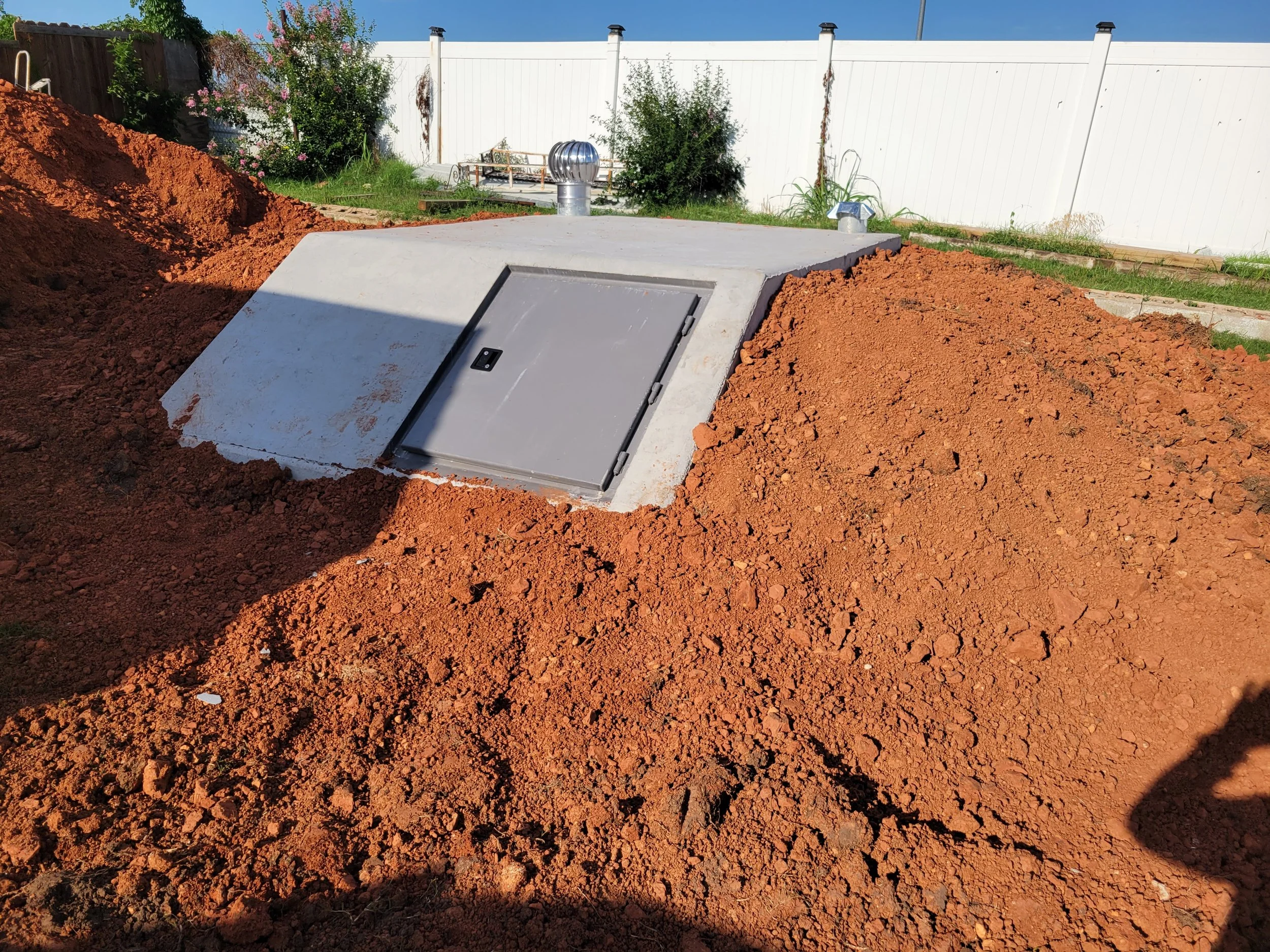 inground Storm Shelter freshly packed before sod has been placed near Oklahoma City