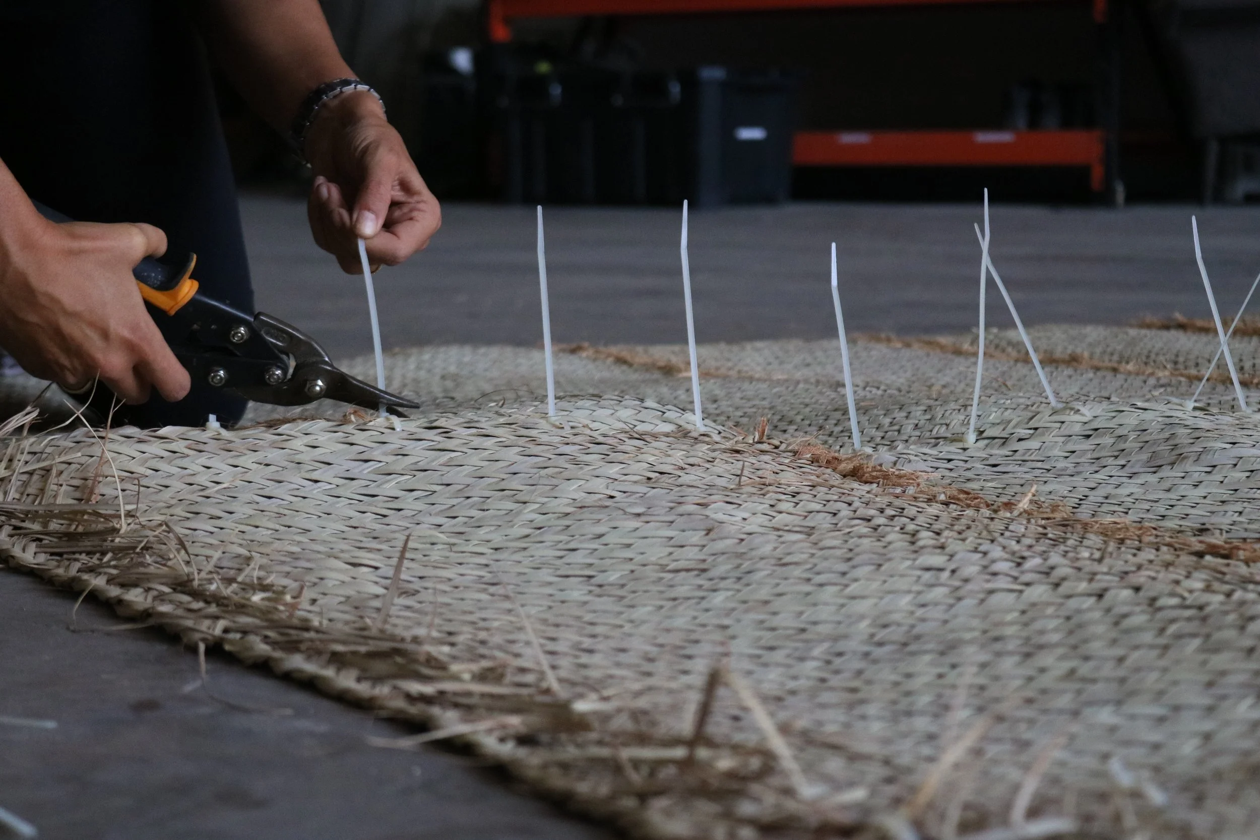 Commissioned for 2026 Doha Design, UNDERSTOREY explores the informal practice of resting beneath urban trees in the UAE. Mycelium is grown across traditional woven palm-leaf haseera mats, transforming them into bio-based surfaces that mediate between
