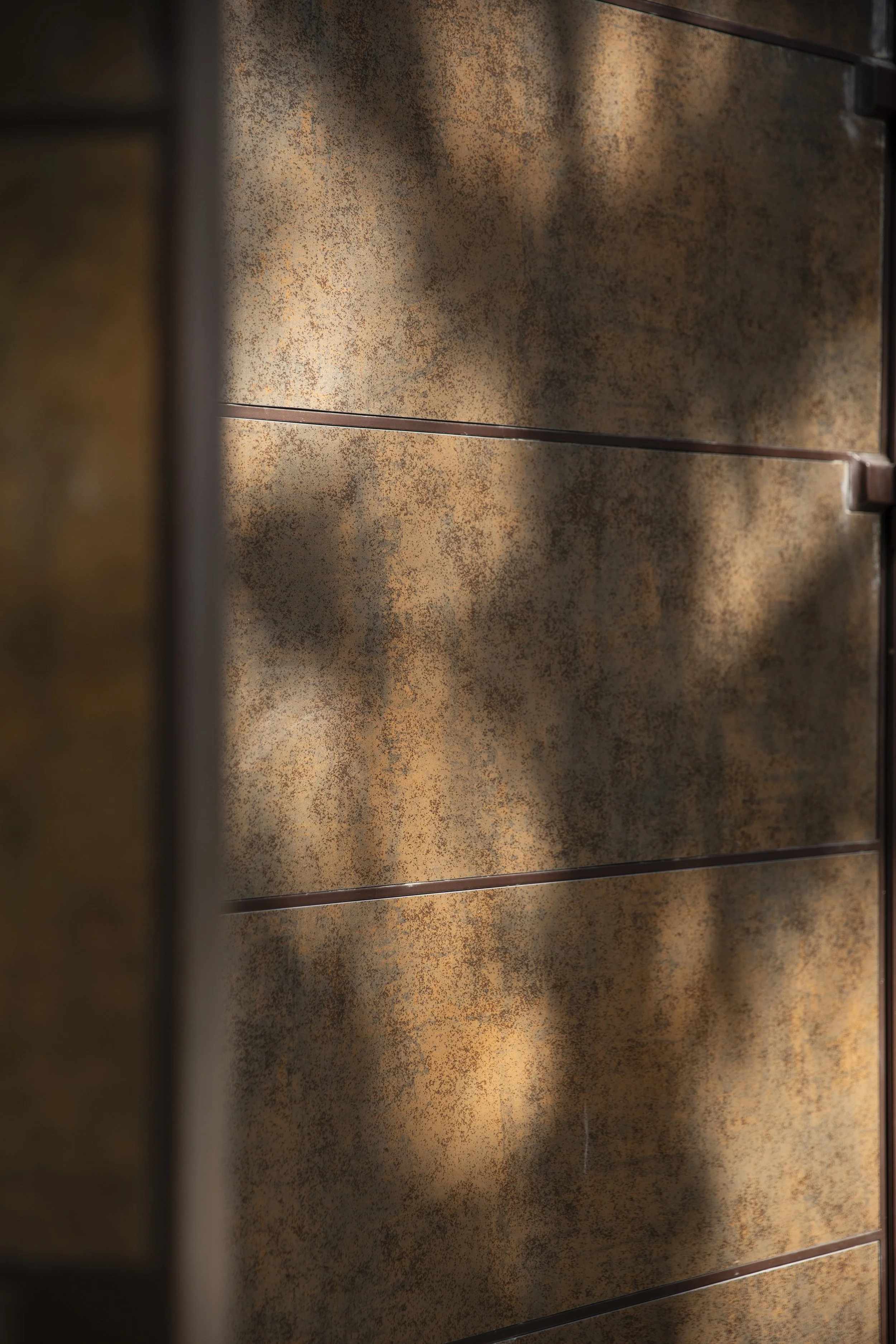  A new entrance door inserted into a widened opening in the existing boundary wall invites new residents into their shared space.