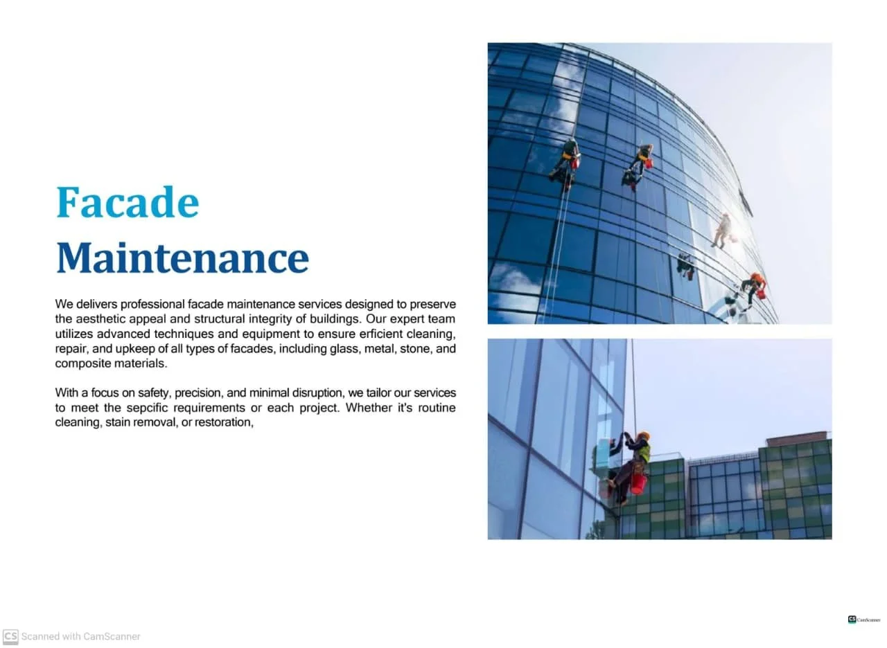 Workers cleaning and maintaining the glass facade of a high-rise building with hanging ropes and cleaning equipment.