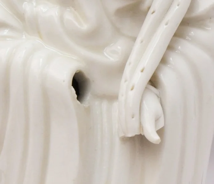 Guanyin figurine close up of damage
