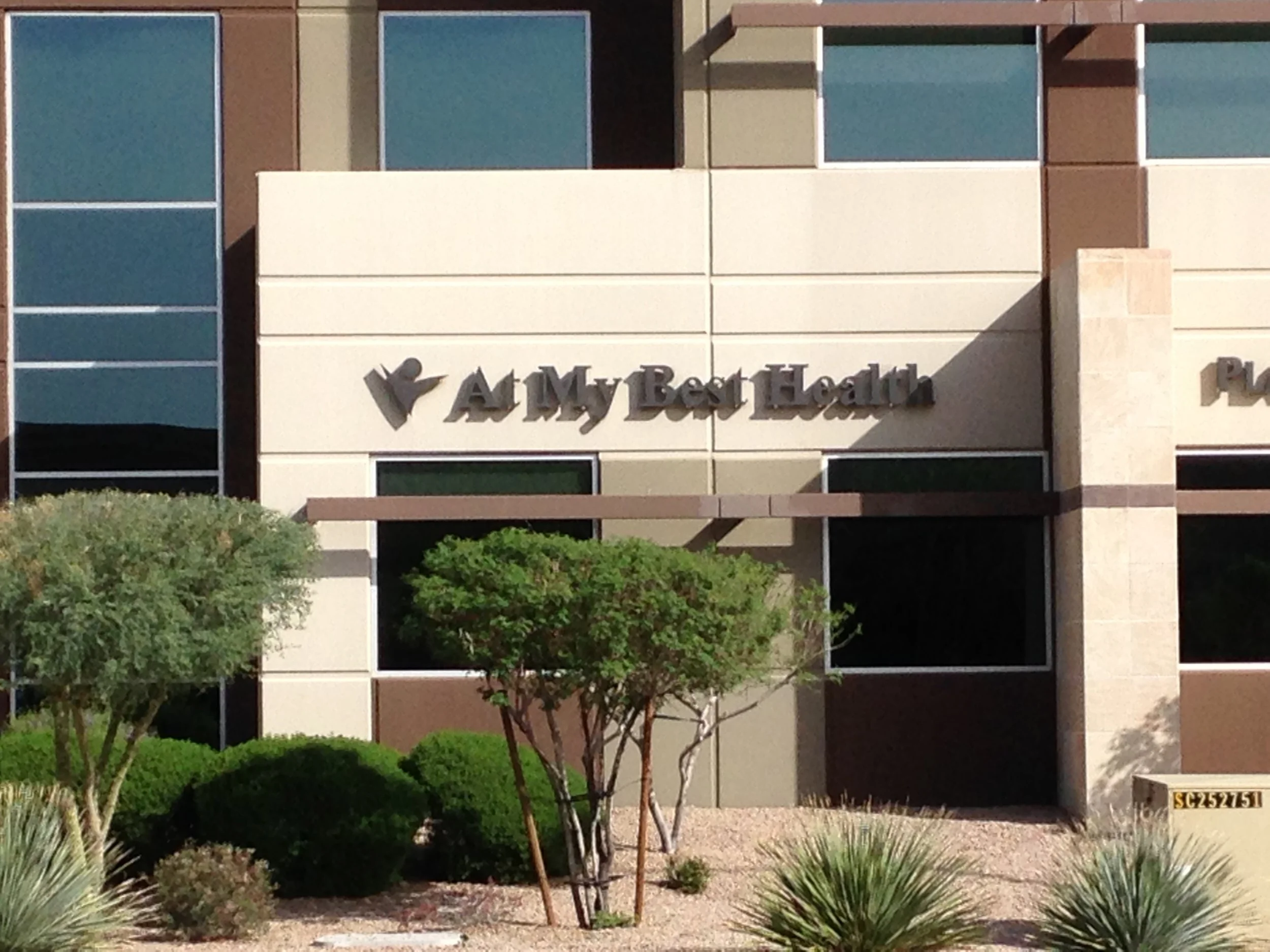 Front view of At My Best Health office in Phoenix, AZ, showing brown walls and expansive windows.