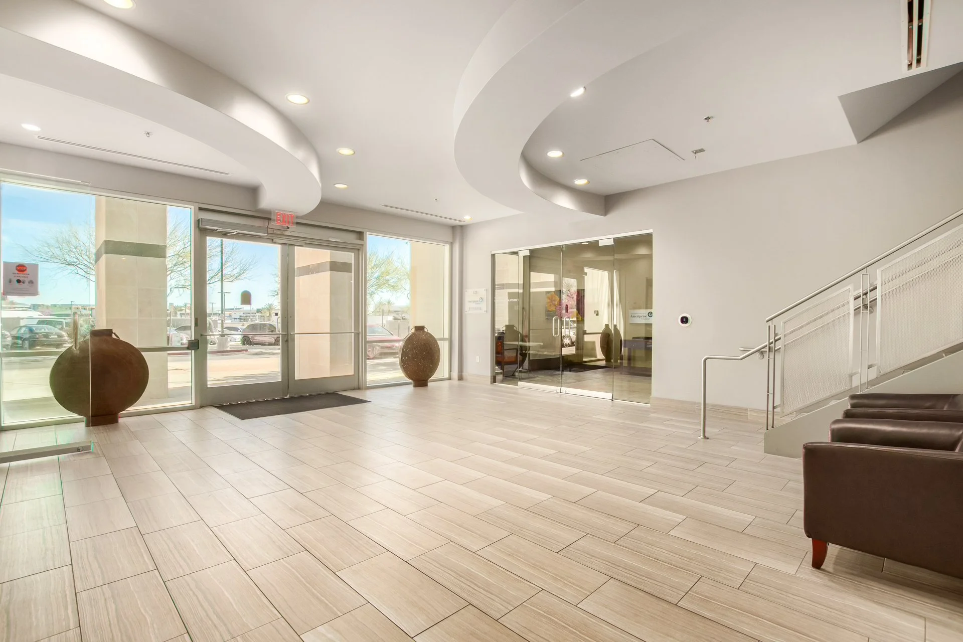 Entrance lobby for the business At My Best Health with marble floors and glass sliding doors.