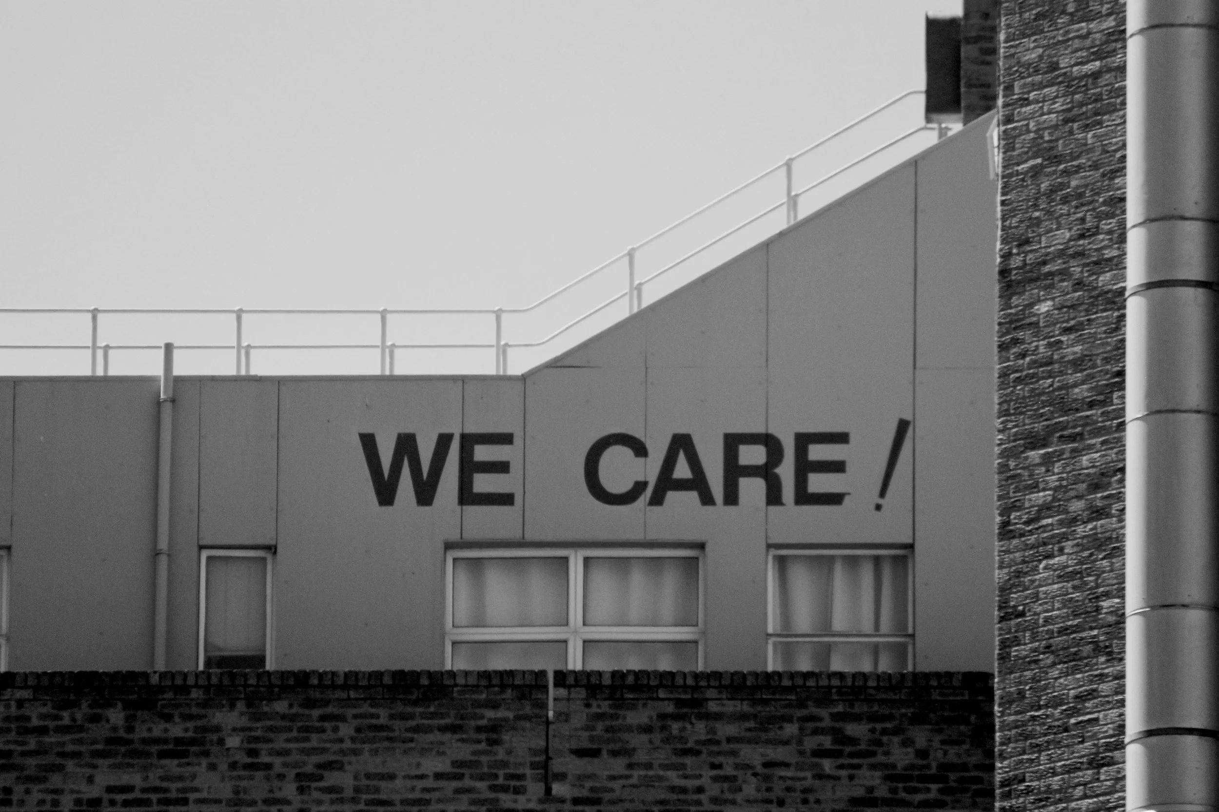 Building with a sign that reads 'WE CARE!'