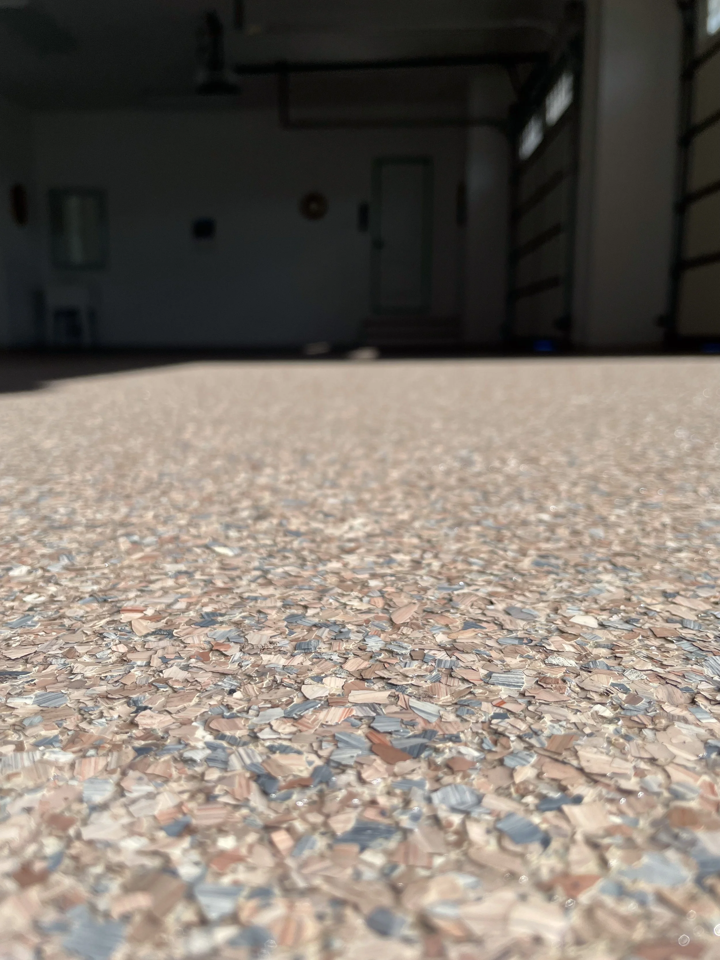 “Finished epoxy garage floor with gray flake system and smooth polyaspartic topcoat.”