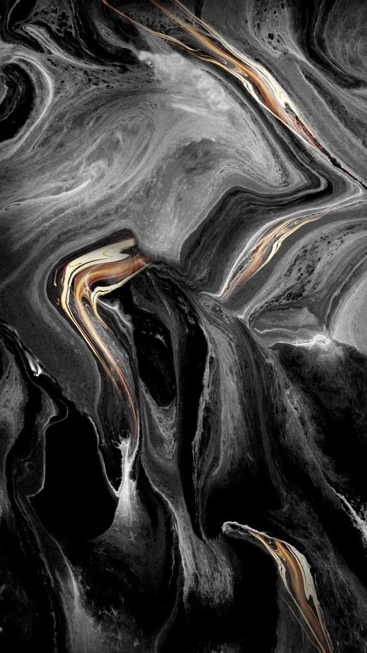 Abstract black, gray, gold, and white swirling marble pattern