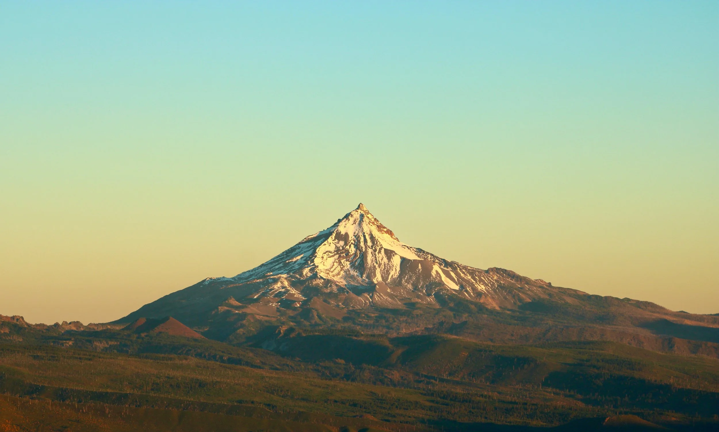 Snow-capped mountain against a clear sky in the landscape.