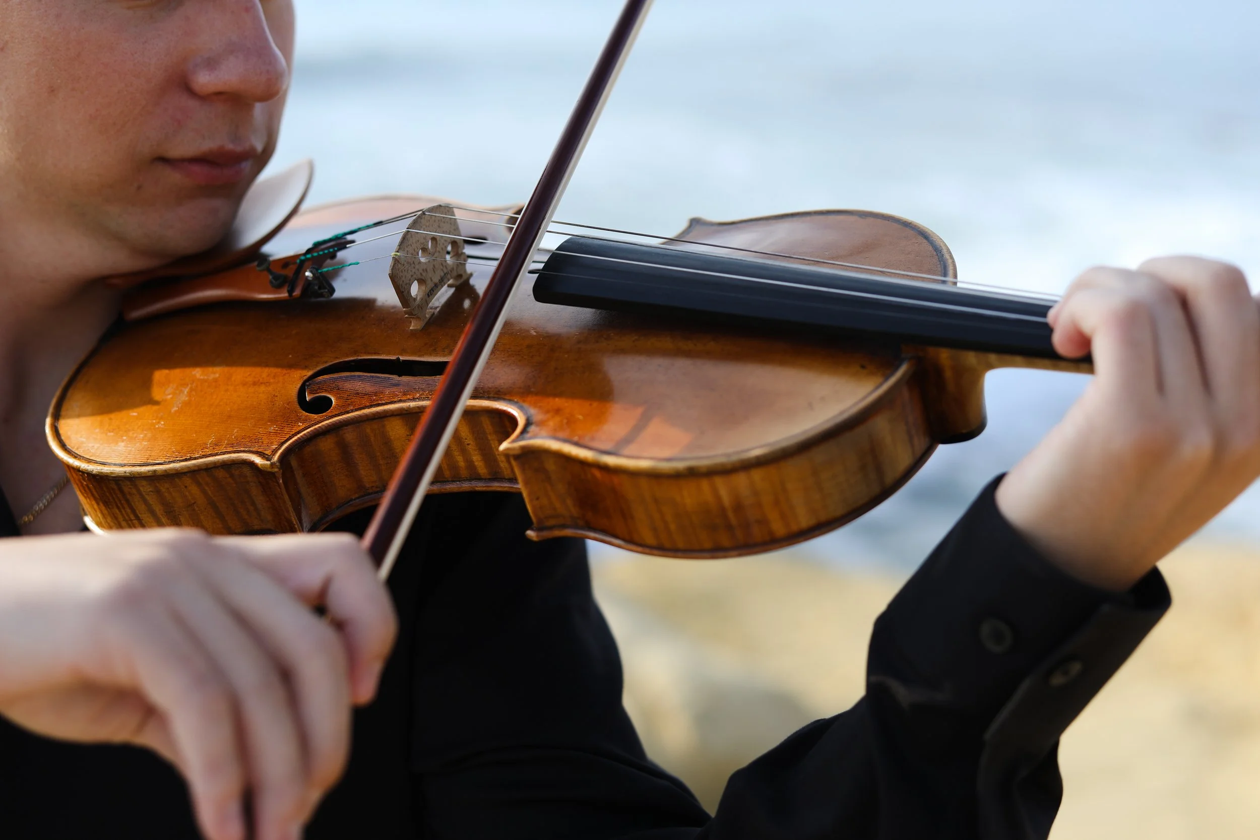 Close up of Adrian playing the violin