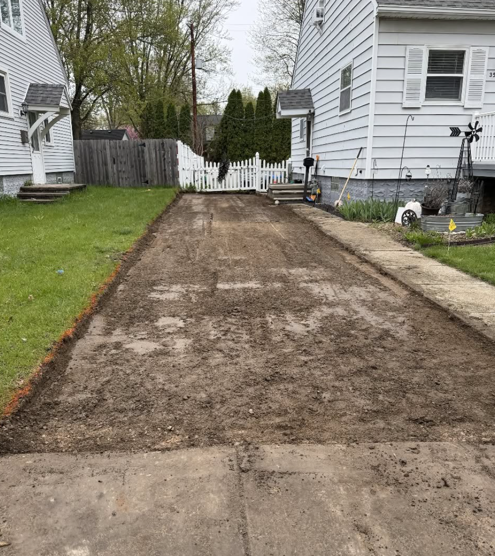 Driveway grading and site preparation in progress using professional excavation equipment by Elite Excavating.
