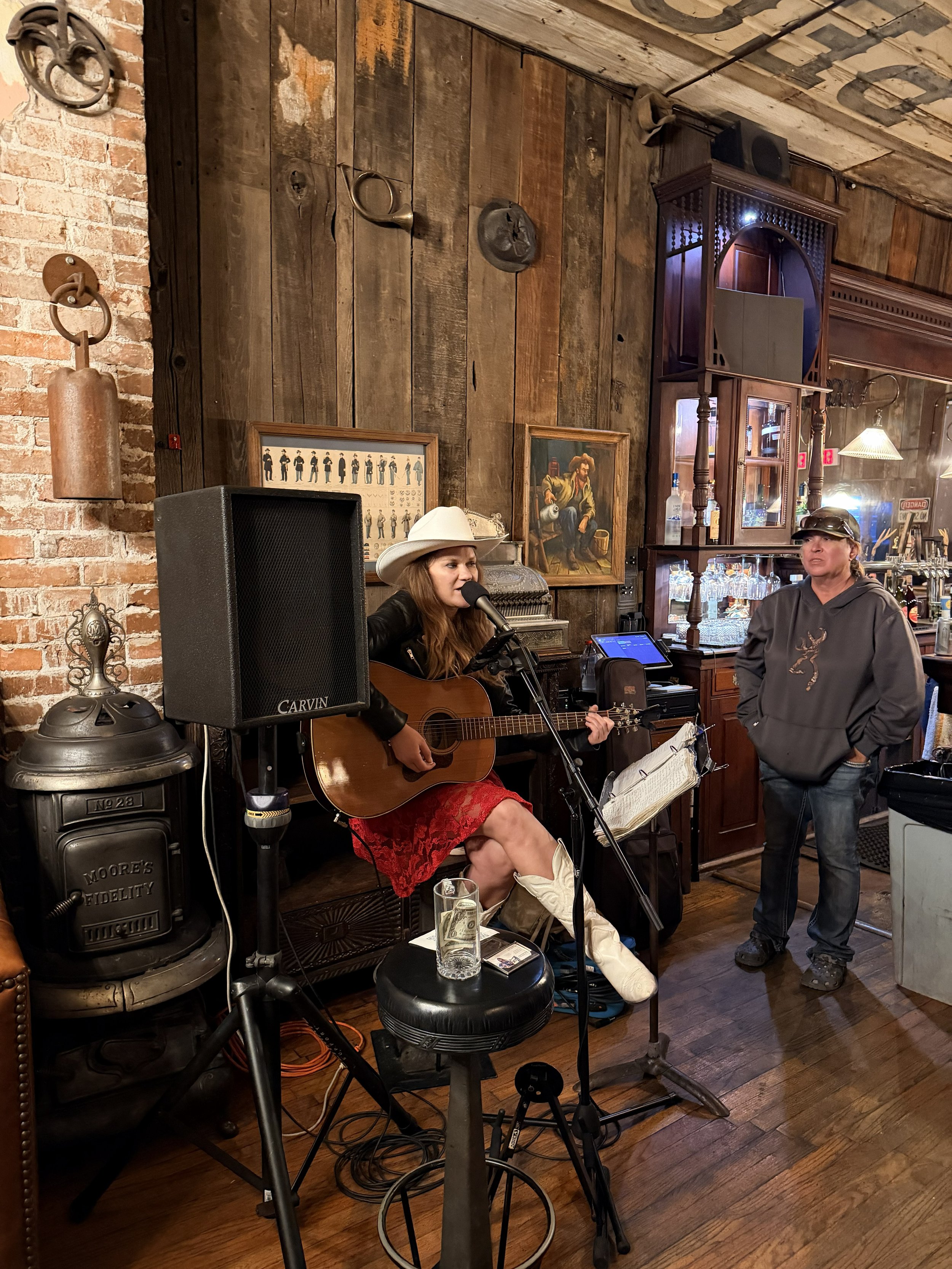singer with guitar and microphone at the Saloon at 1880 Union Hotel in Los Alamos California