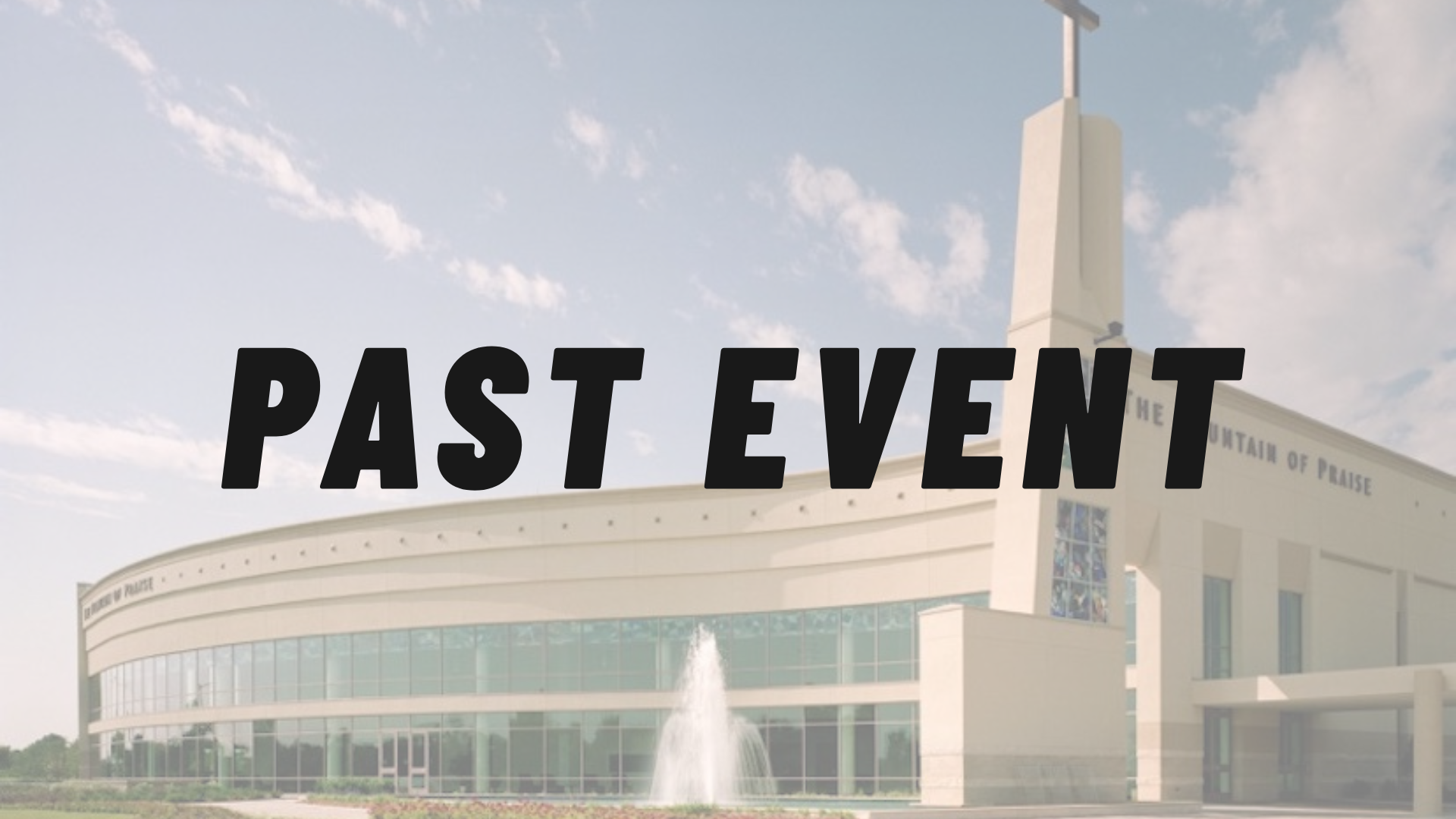 Exterior view of The Fountain of Praise church building with a cross on top, large stained glass windows, and a water fountain in front, surrounded by a flower bed under a partly cloudy sky.