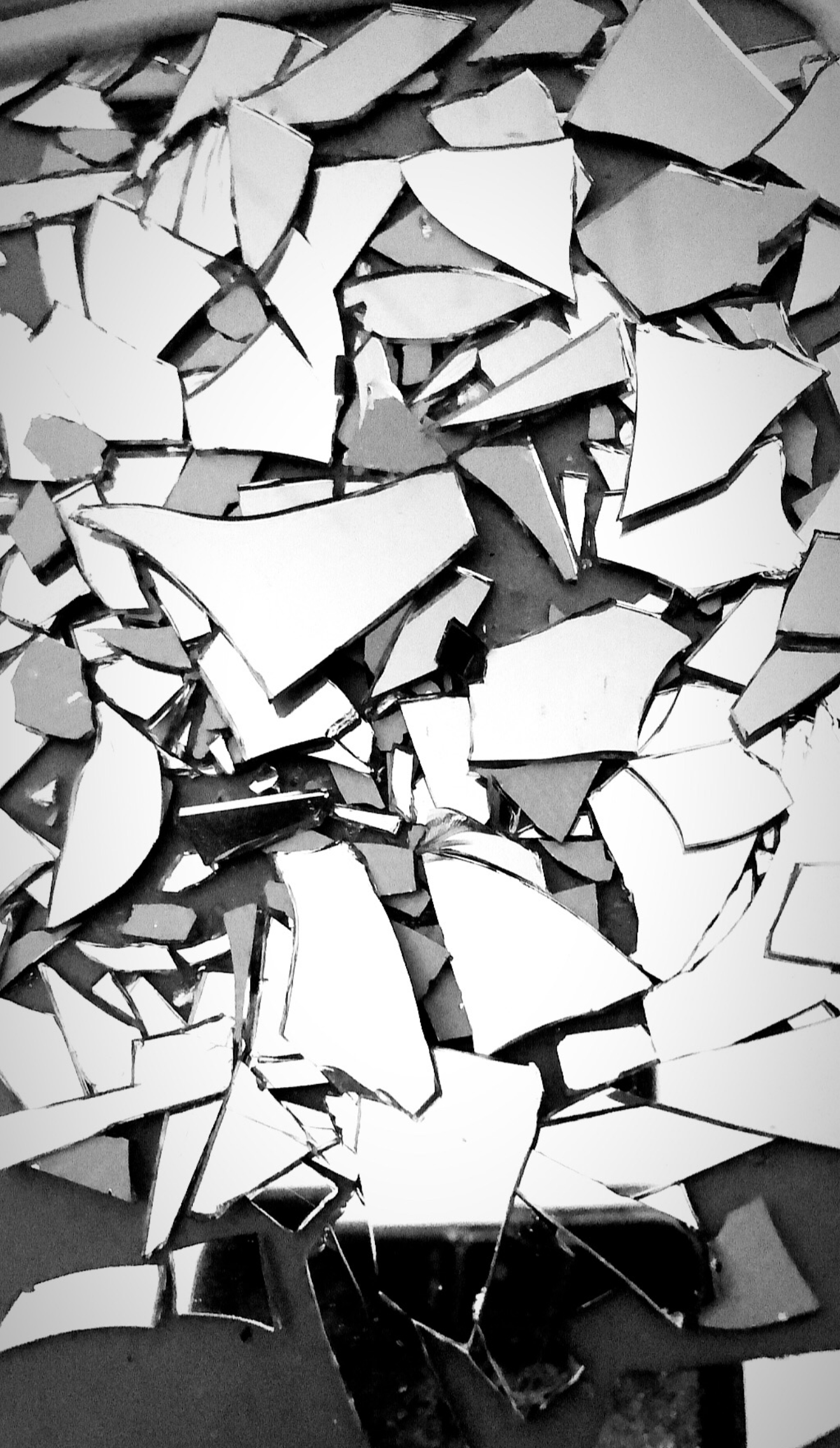 Broken mirror shards scattered in a pile.