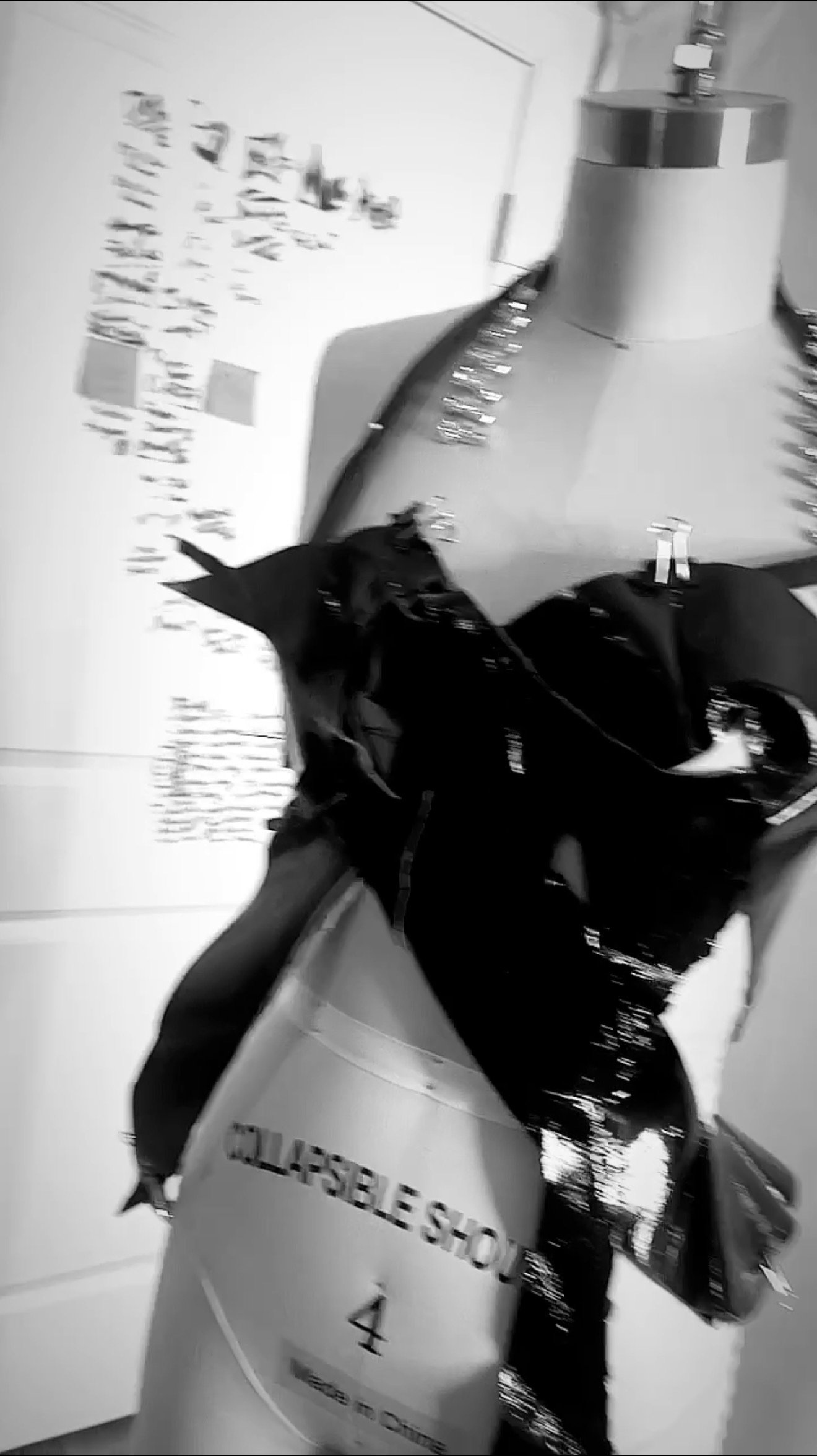 Close-up of a cardboard tube with the words 'TOUCH & GROW' printed on it, surrounded by a plastic bag and objects on top of a piece of furniture or display.