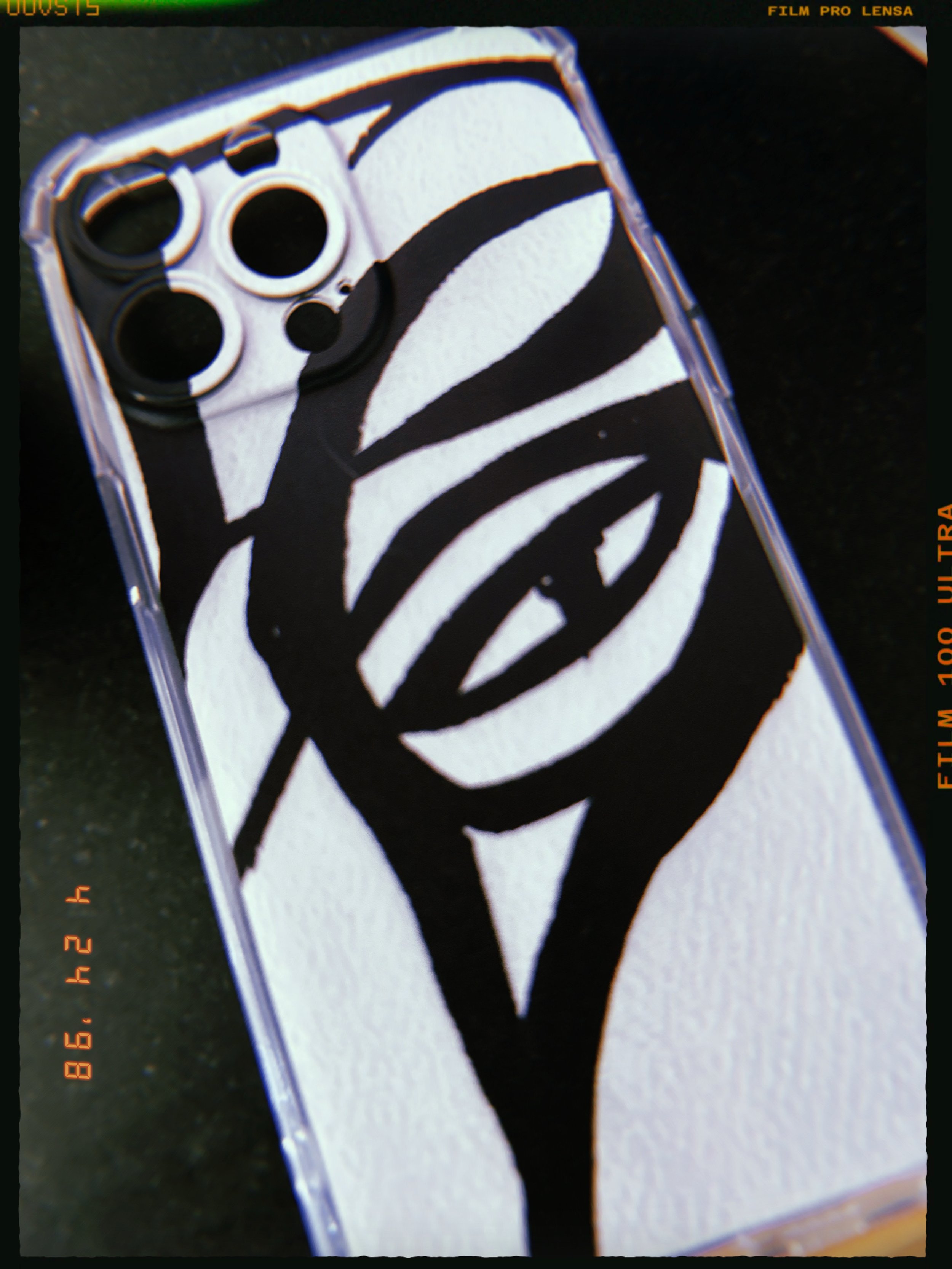 Phone case with a black and white zebra stripe pattern.
