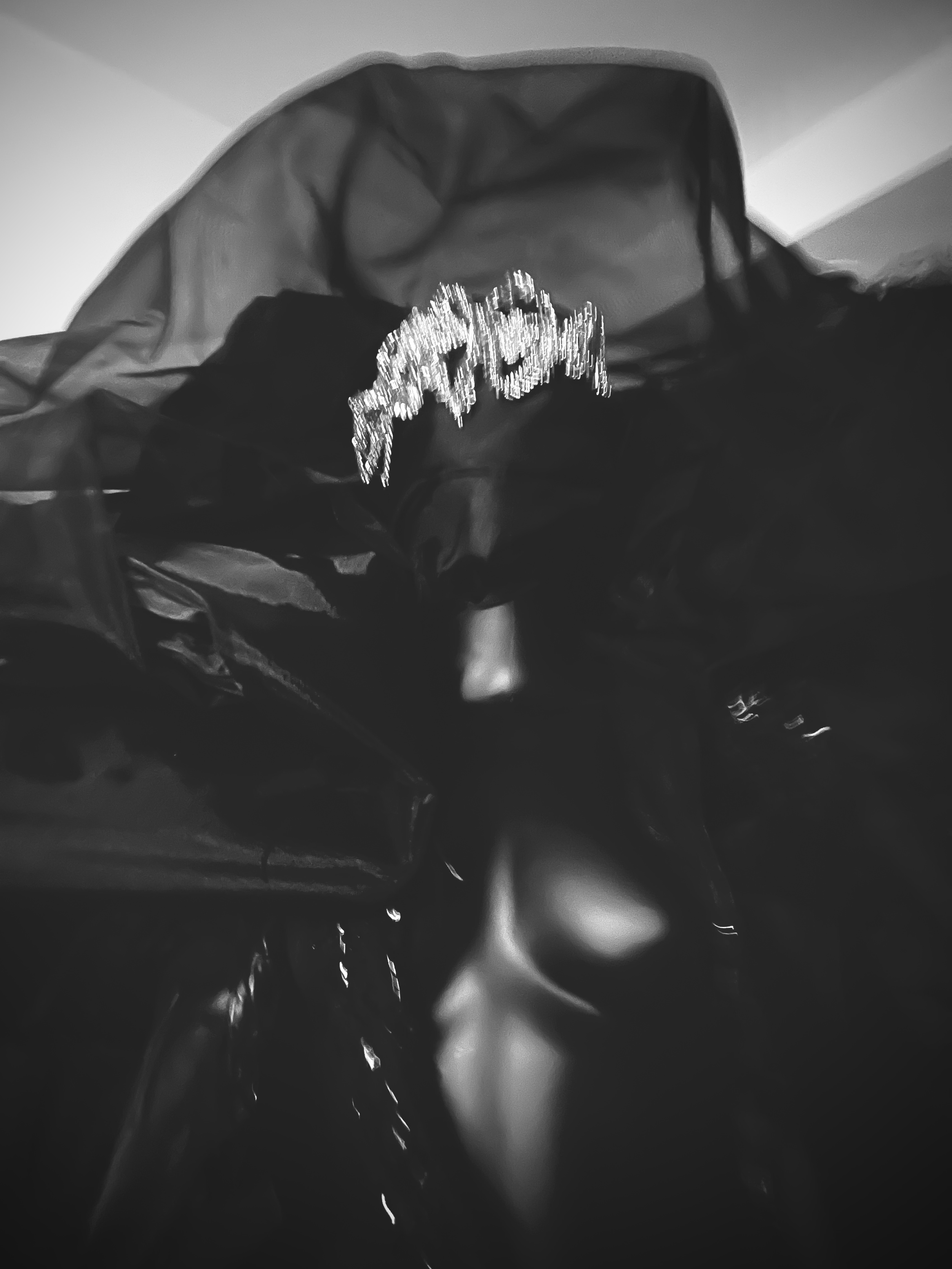 Close-up of black plastic bags with reflective text on top and a mannequin face partially visible underneath.