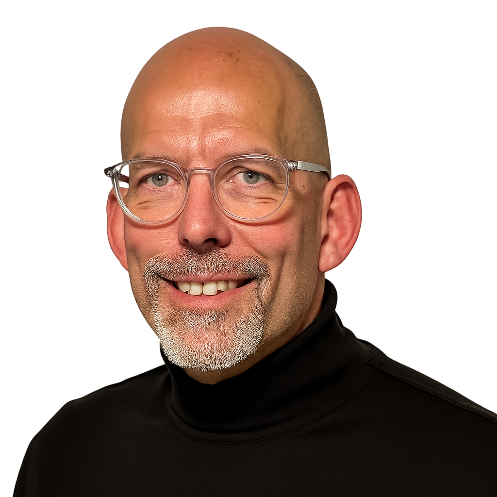A smiling Dr Dirk Hines, a middle-aged man with glasses, a goatee, and a shaved head, wearing a black turtleneck.