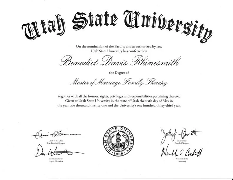 Diploma from Utah State University awarded to Benedict Davis Rhinesmith for Master of Marriage Family Therapy, dated 2021, with signatures and official seal.