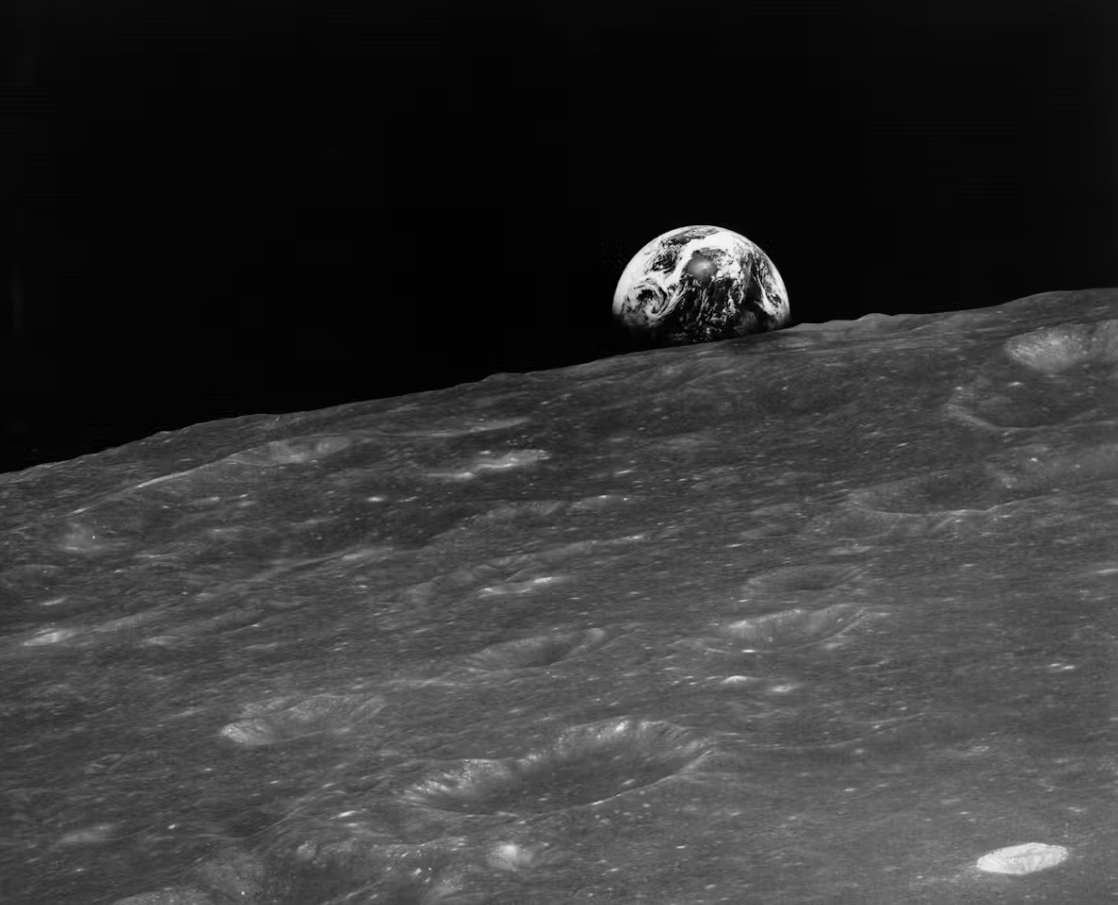 View of the Moon's surface with Earth in the background.
