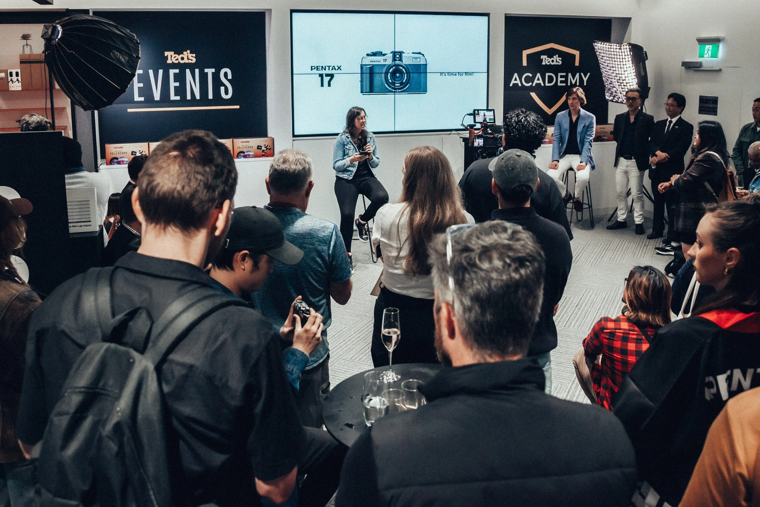 Josie giving a speech to a crowd about the Pentax 17 at Ted's Gallery in Sydney