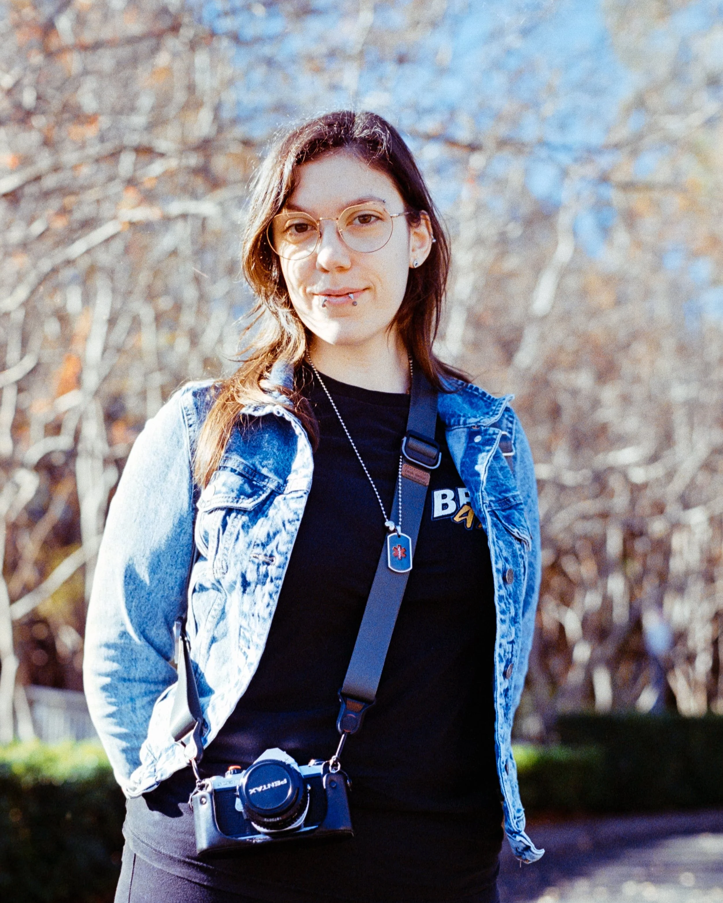 Josie at the Temple with her Pentax, smiling at the camera