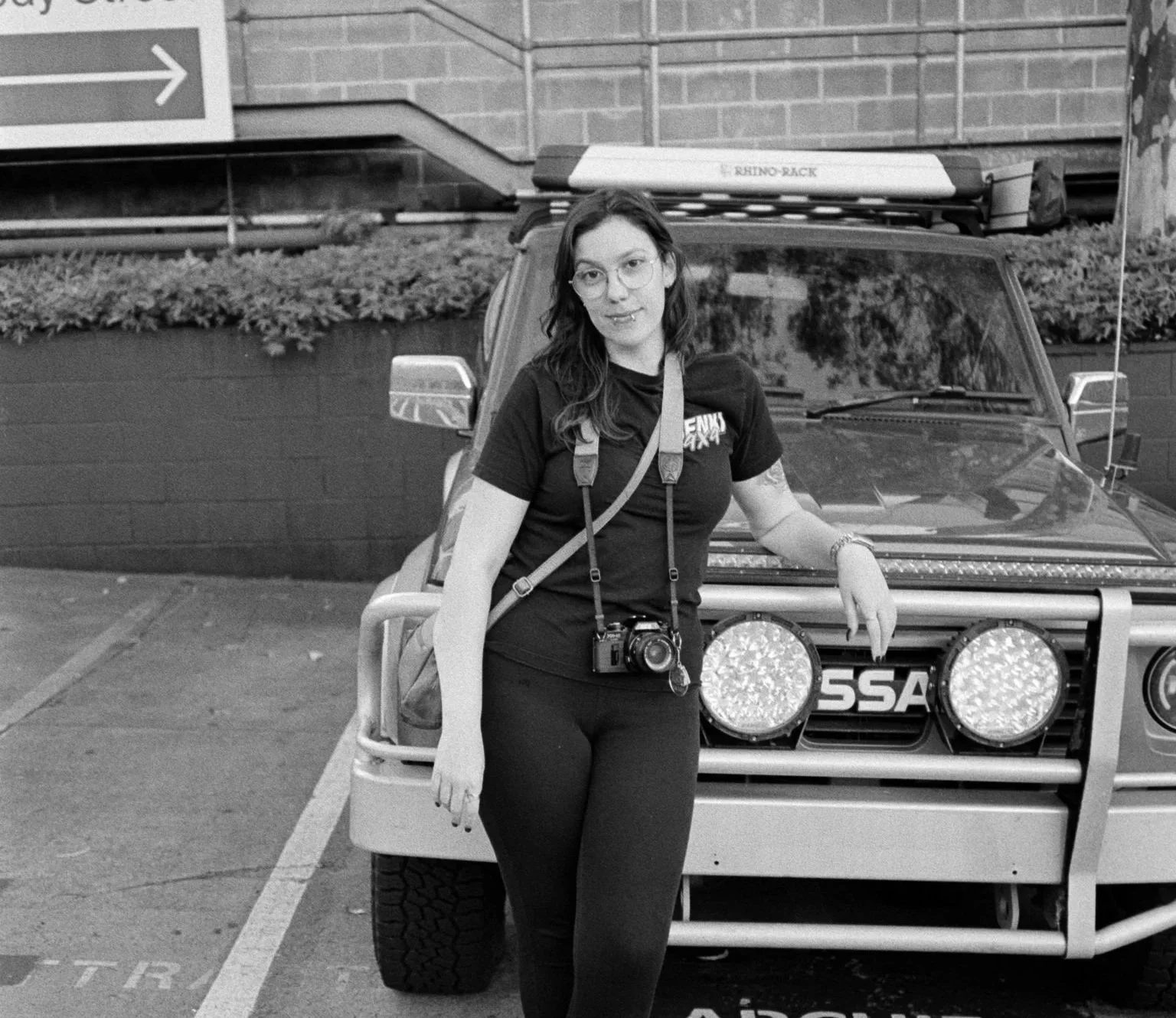 Josie smiling brightly while leaning against her GQ Patrol named Scorpion, captured by Hashem McAdam